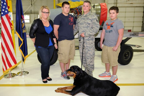 130914-Z-EZ686-388 -- The Stutts family, mom Sarah, Daniel, Staff Sgt. Daniel and Brendan, are seen in the propulsion shop of the 127th Maintenance Squadron at Selfridge Air National Guard Base, Mich., Sept. 14, 2013. The two sons were honored by SSgt. Stutts’ group commander for bravery in escaping a fire in their home and rescuing the family’s pets, including their dog, Mishka. (U.S. Air National Guard photo by MSgt. David Kujawa/Released)
