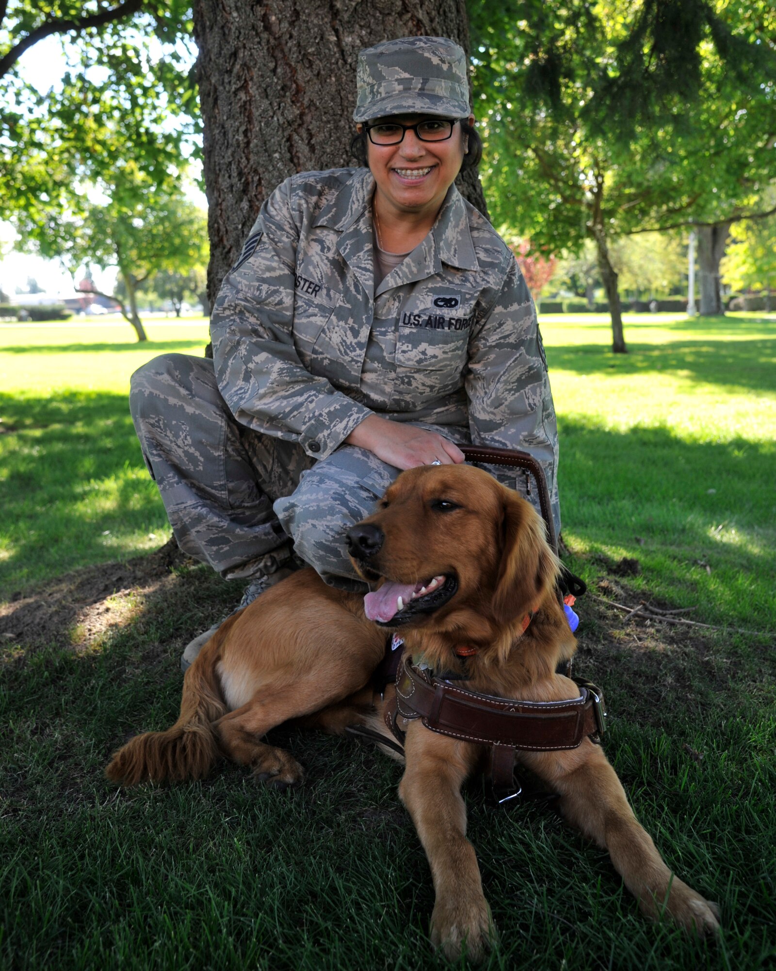 Staff Sgt. Abigail Foster, Phoenix Star program member, poses with her golden retriever, Luke, at Fairchild Air Force Base, Wash., Sept. 12, 2013. The Phoenix Star program is designed to facilitate Airmen's transition into the civilian lifestyle. (U.S. Air Force photo by Senior Airman Mary O'Dell/Released)