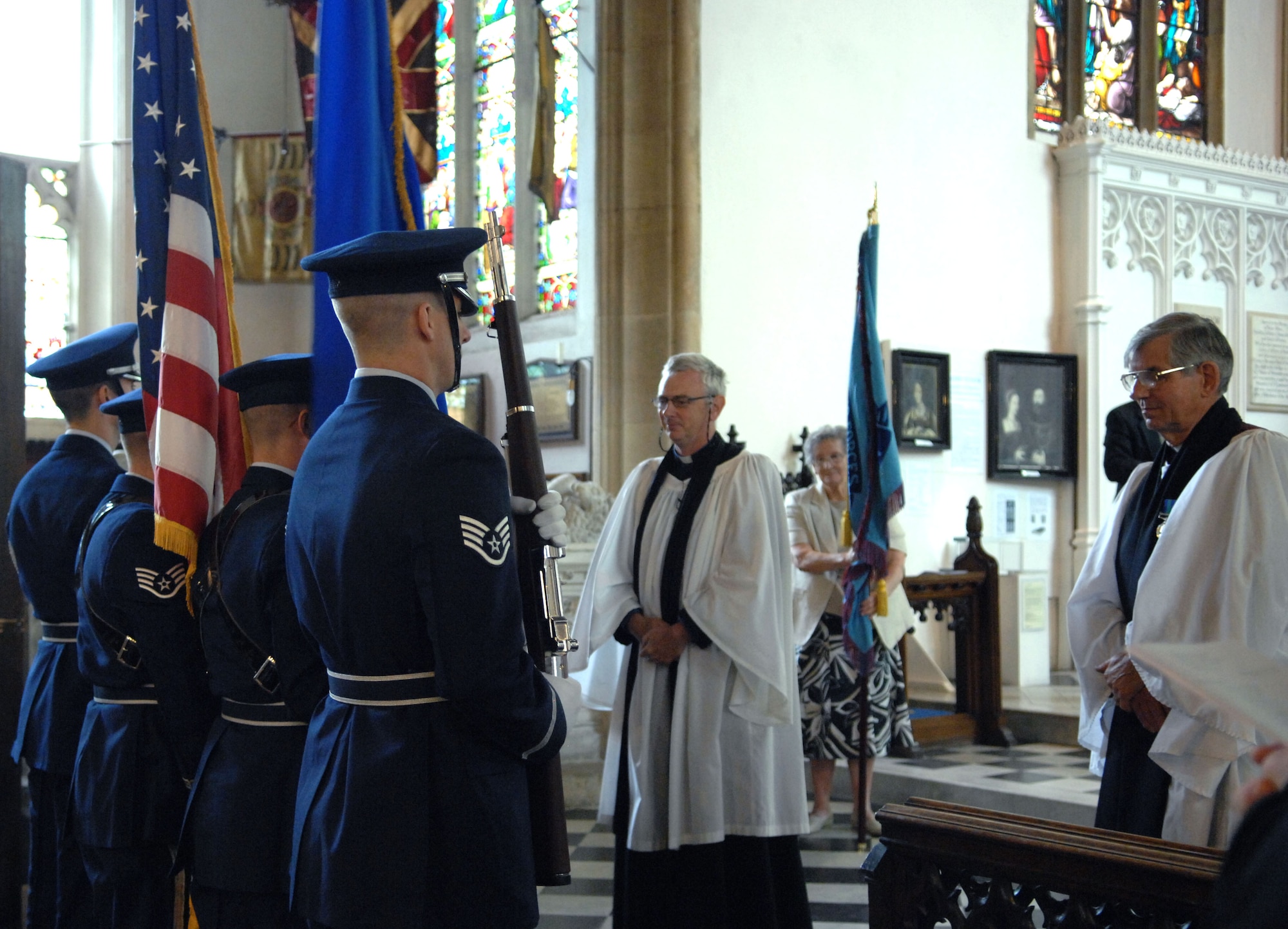 Team Mildenhall honor guard members retrieve the U.S. and U.S. Air Force flags Sept. 15, 2013, following a memorial service during the Battle of Britain memorial parade in Bury St. Edmunds, England. Royal Air Force, U.S. Air Force, RAF retirees and other organizations took part in the parade, each carrying their respective flags. The flags were then displayed in the St. Edmundsbury Cathedral for a memorial service. (U.S. Air Force photo by Airman 1st Class Dillon Johnston/Released)