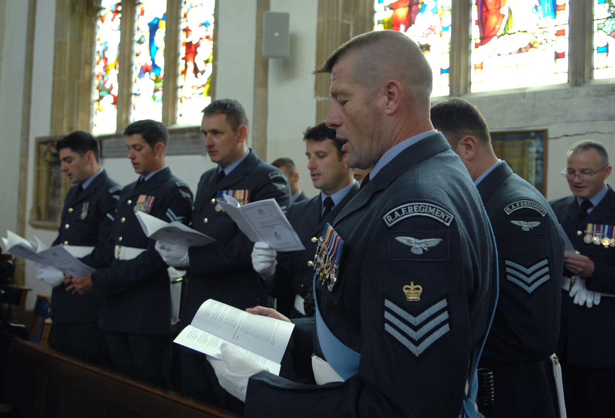 Royal Air Force members sing hymns Sept. 15, 2013, in the St. Edmundsbury Cathedral during the Battle of Britain memorial parade in Bury St. Edmunds, England. The parade started in the Abbey Gardens and proceeded to the cathedral where a memorial service was held. The service honored those who died during the Battle of Britain. (U.S. Air Force photo by Airman 1st Class Dillon Johnston/Released)