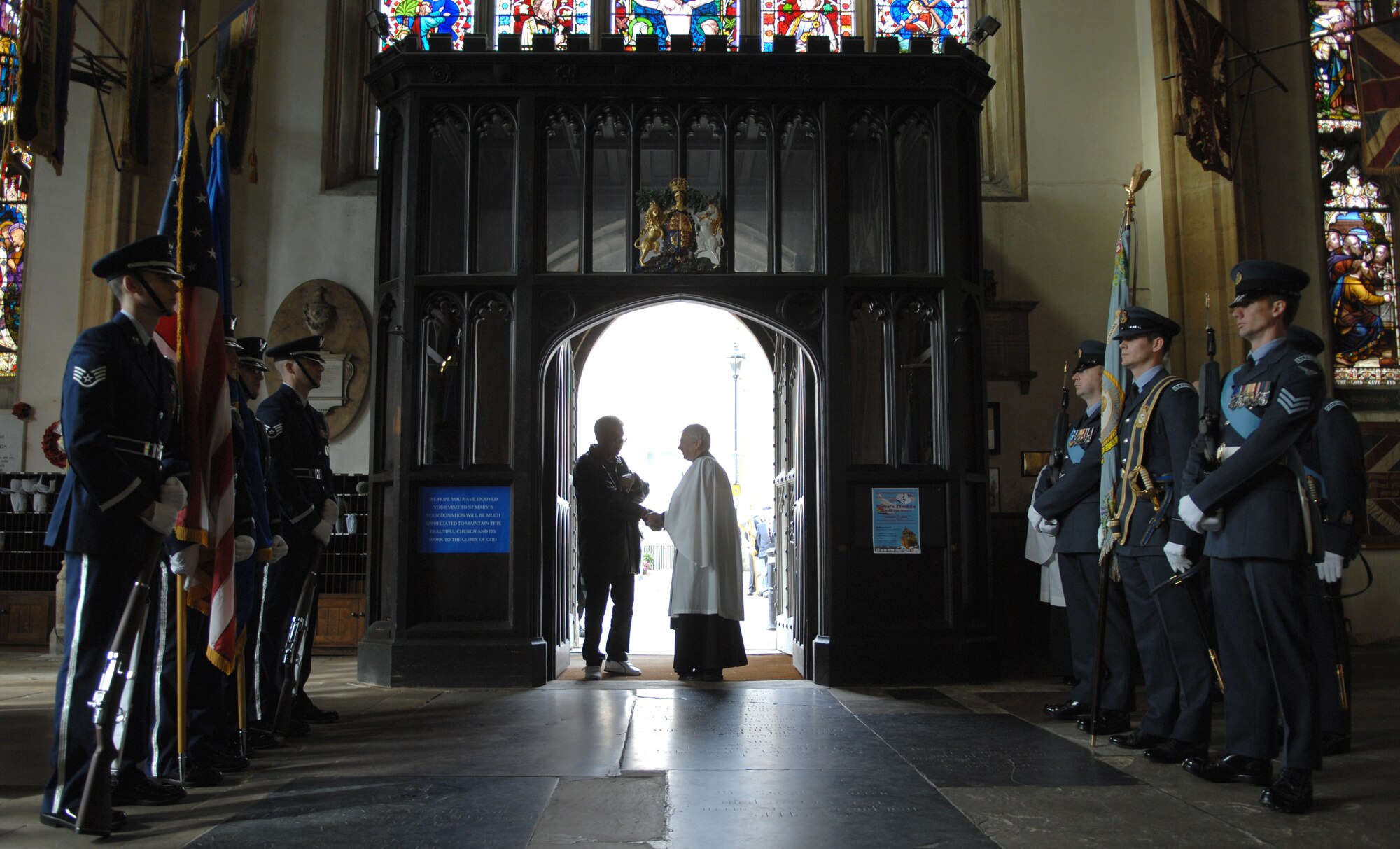 Team Mildenhall and Royal Air Force honor guard members display their respective flags Sept. 15, 2013, at the entrance of the St. Edmundsbury Cathedral during the Battle of Britain memorial parade in Bury St, Edmunds, England. The parade paid tribute to the battle the Royal Air Force fought in 1940 against the Luftwaffe. The battle proved to be a turning point for Britain in World War II, and is commemorated every year on Sept. 15. (U.S. Air Force photo by Airman 1st Class Dillon Johnston/Released)