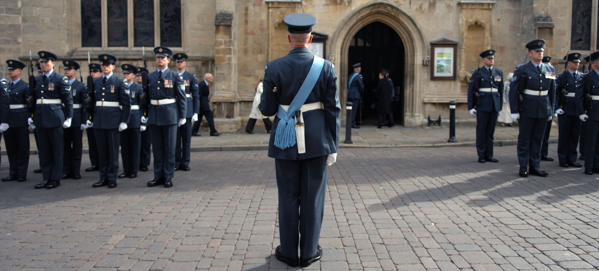 A Royal Air Force member commands an RAF squadron Sept. 15, 2013, during the Battle of Britain memorial parade in Bury St. Edmunds, England. The parade started in the Abbey Gardens and proceeded to the St. Edmundsbury Cathedral where a memorial service was held. The service honored those who died during the Battle of Britain. (U.S. Air Force photo by Airman 1st Class Dillon Johnston/Released)