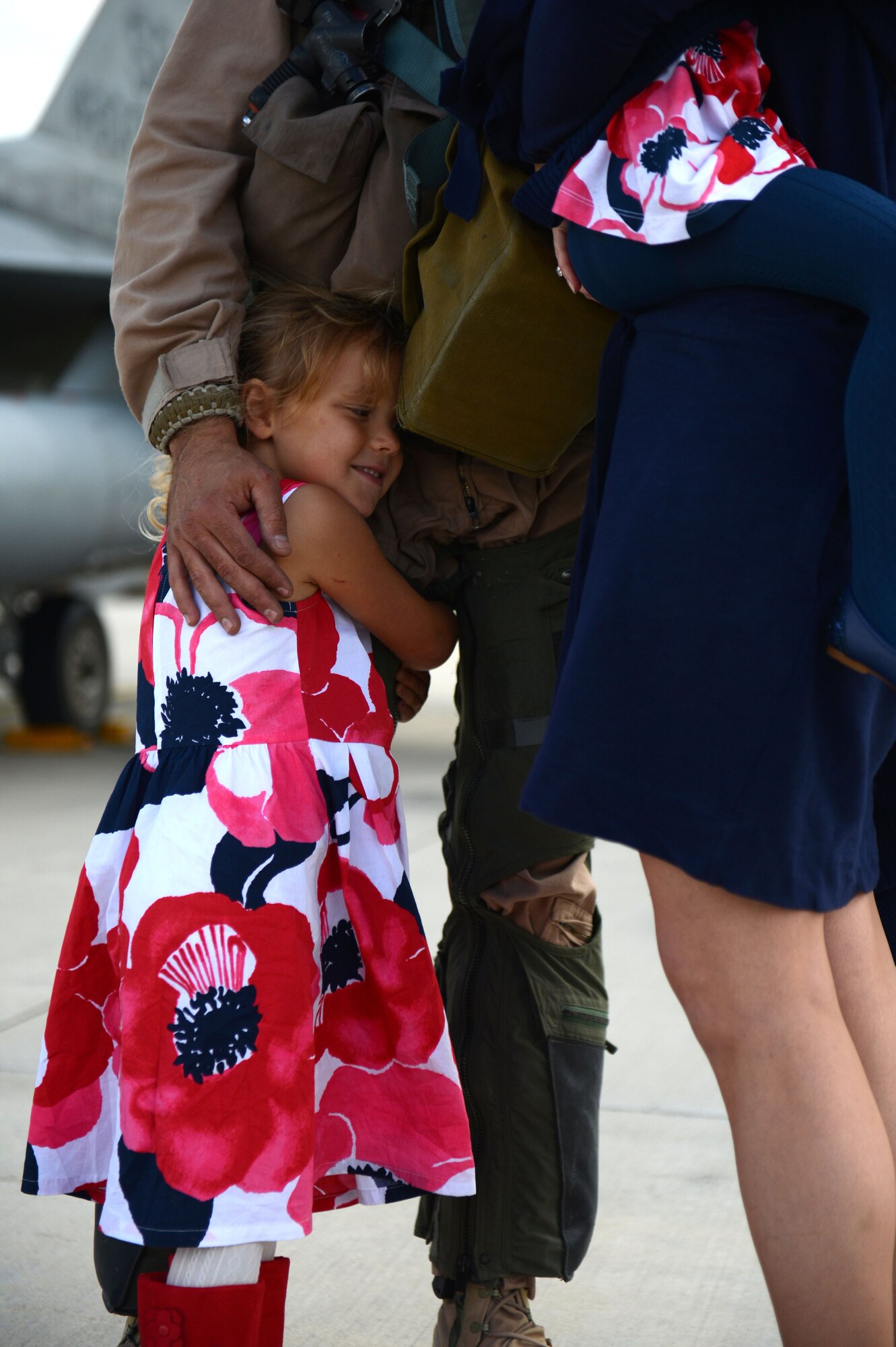 SPANGDAHLEM AIR BASE, Germany – Abigail Chalverus, daughter of U.S. Air Force Lt. Col. Marshall Chalverus, 480th Fighter Squadron leadership from Seattle, hugs her father during a deployment homecoming Sept. 15, 2013. More than 100 friends, family and Airmen showed up to support the event. (U.S. Air Force photo by Airman 1st Class Gustavo Castillo/Released)
