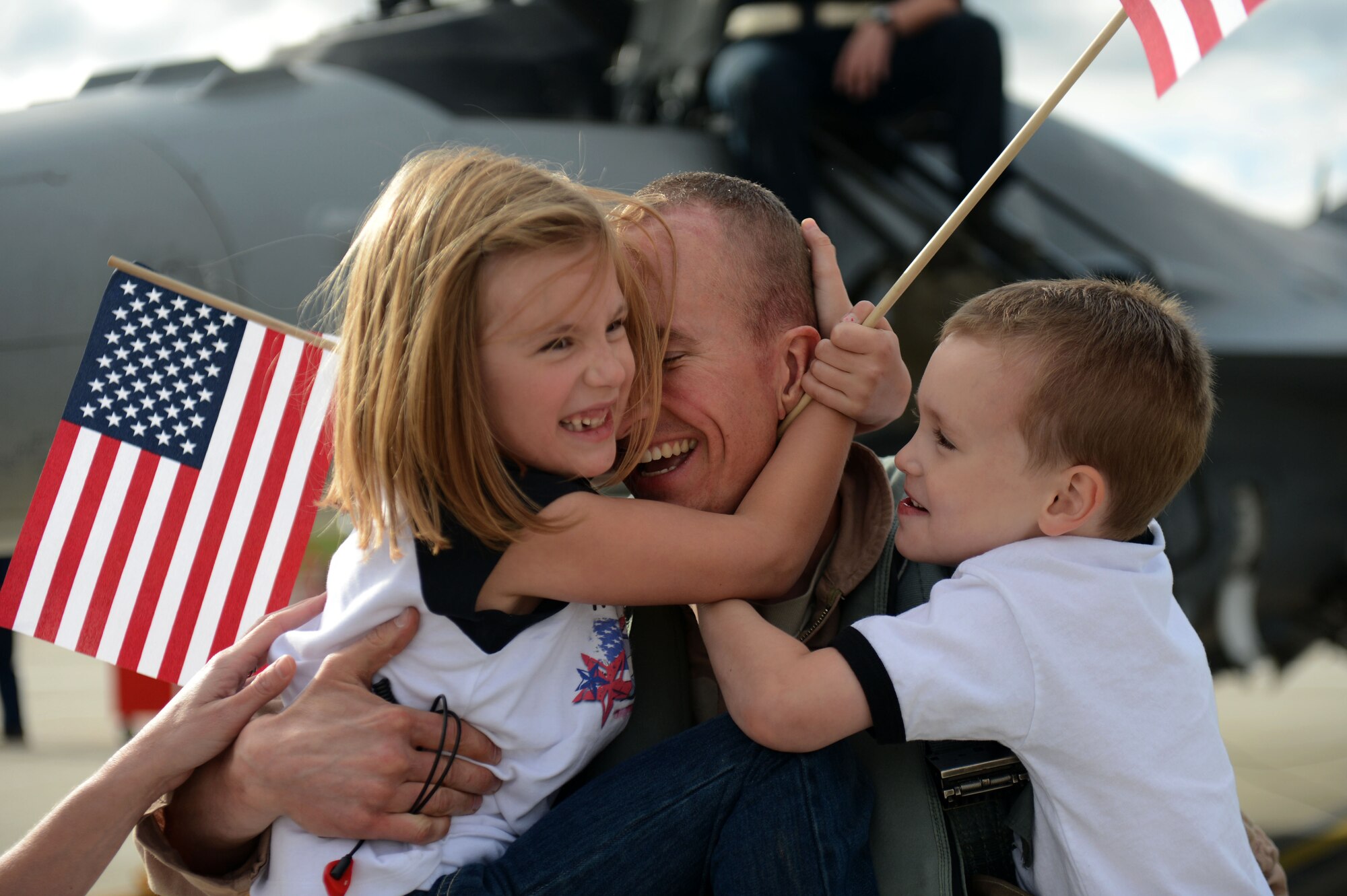 SPANGDAHLEM AIR BASE, Germany – U.S. Air Force Maj. Greg Boland, 480th Fighter Squadron pilot from Reading, Pa., hugs his children Rylie and Carter Sept. 15, 2013, after returning from a deployment. Airmen assigned to the 480th FS train to provide decisive combat power to combatant commanders for contingency operations down range. (U.S. Air Force photo by Airman 1st Class Gustavo Castillo/Released)