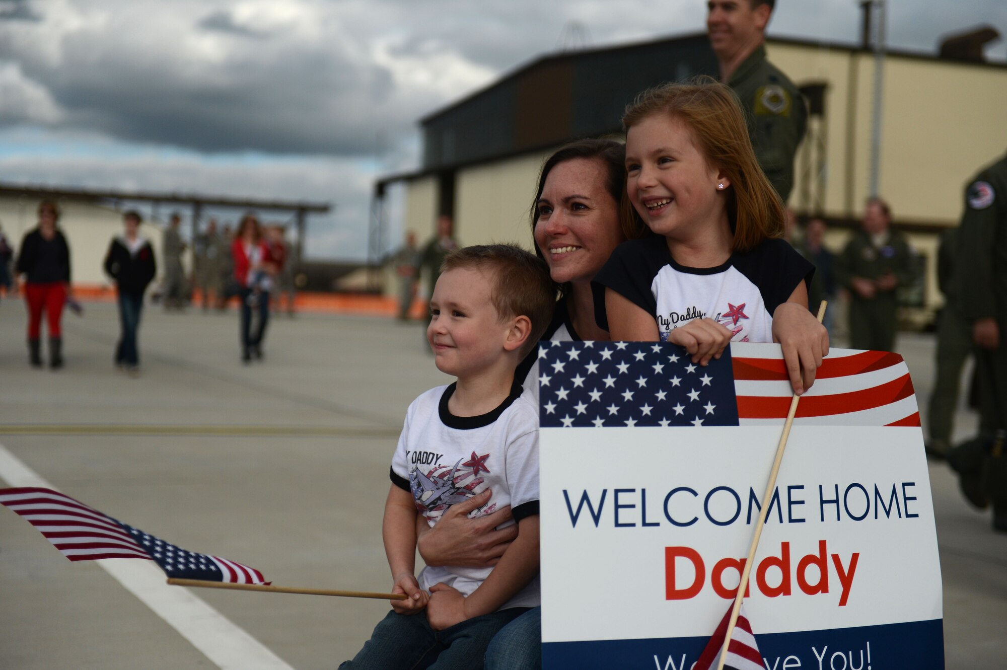 SPANGDAHLEM AIR BASE, Germany – Lisa Boland, and her children Carter and Rylie, wait in suspense during a deployment homecoming Sept. 15, 2013. More than 100 friends, family and Airmen showed up to support the event. (U.S. Air Force photo by Airman 1st Class Gustavo Castillo/Released)