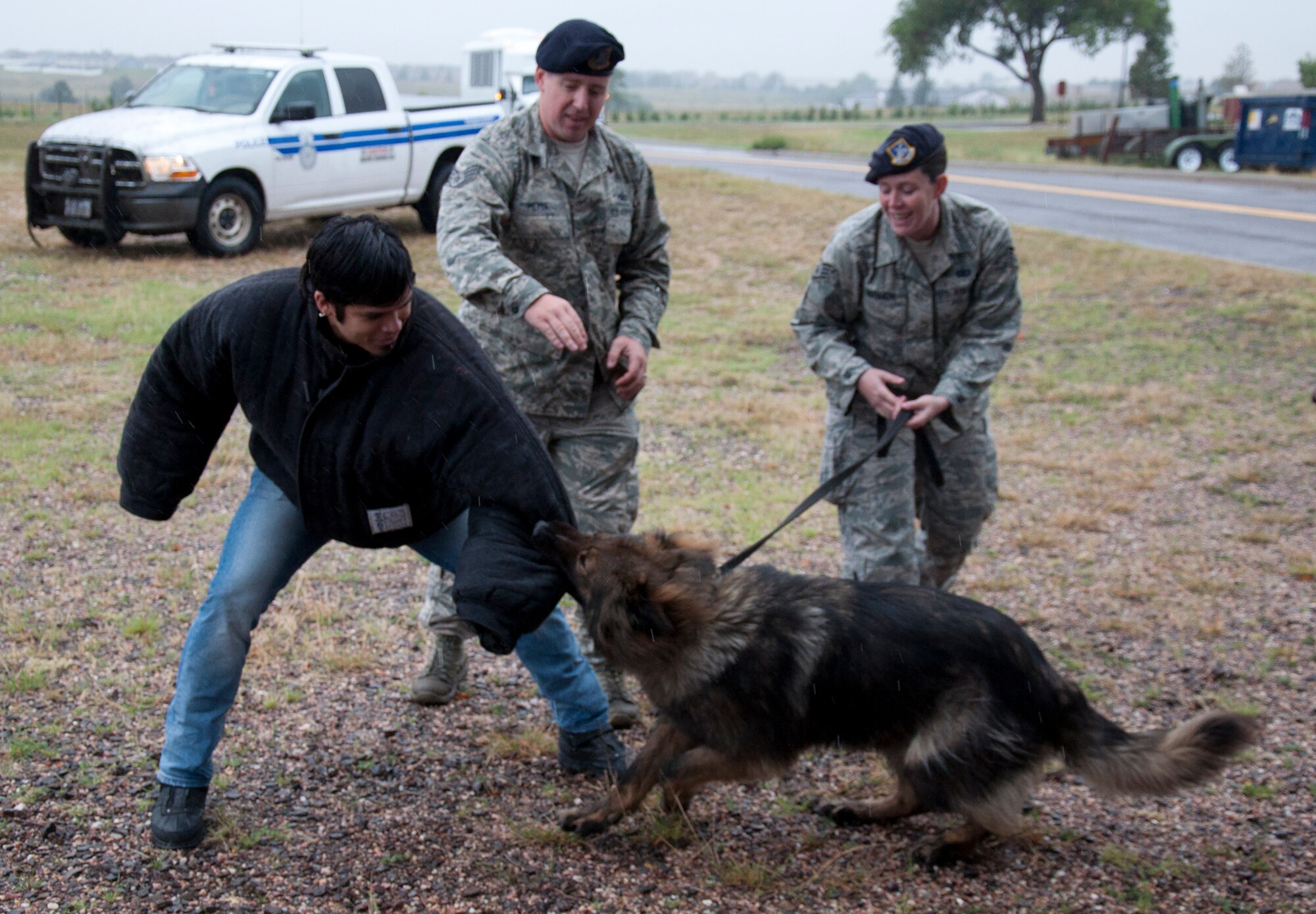 130911-F-GZ967-015 Jason Moreno, lead singer for the band Drowning Pool, learned what it feels like to be a victim of the 90th Security Forces military working dogs Sept. 11, 2013. Ben, a 6-year-old, long-haired German Sheppard, and his handler Staff Sgt. Ginger Redmon, 790th Missile Security Forces Squadron, gave a demonstration to the band on the capabilities of the military working dogs here on F.E. Warren Air Force Base, Wyo. (U.S. Air Force photo by Airman 1st Class Brandon Valle)