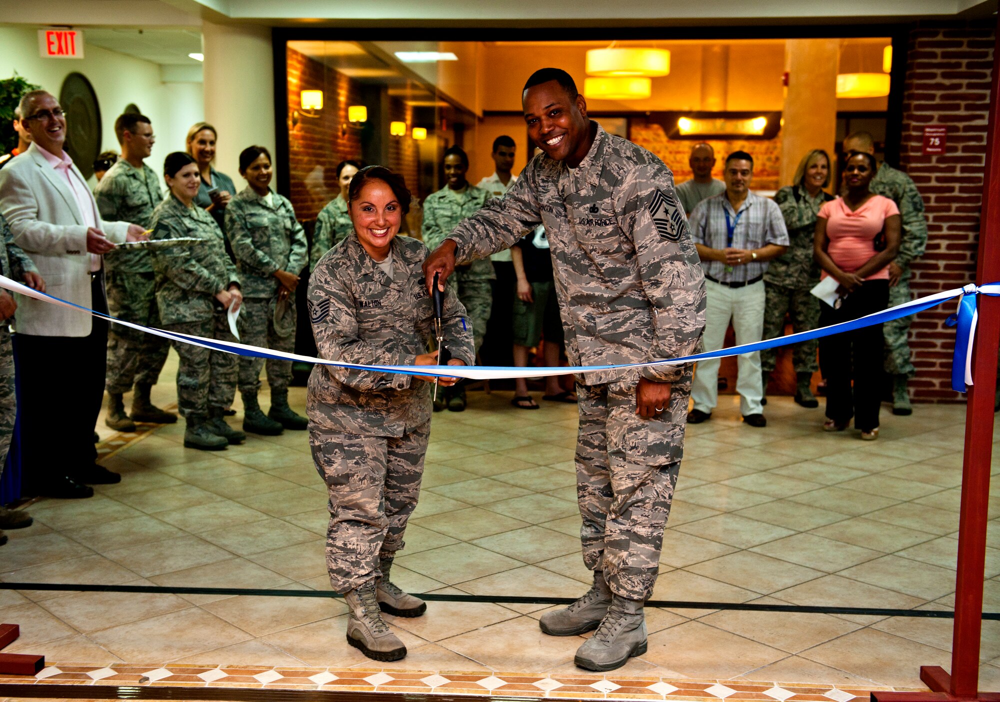 Chief Master Sgt. Anthony Johnson, 39th Air Base Wing command chief, and Tech. Sgt. Sharlyne Walton, 39th Air Base Wing NCO in charge of knowledge operations management, cut the ribbon for the grand opening of the enlisted club Sept. 13, 2013, at Incirlik Air Base, Turkey. The enlisted club was renovated with a new design by Incirlik’s own enlisted team. (U.S. Air Force photo by Senior Airman Daniel Phelps/Released)