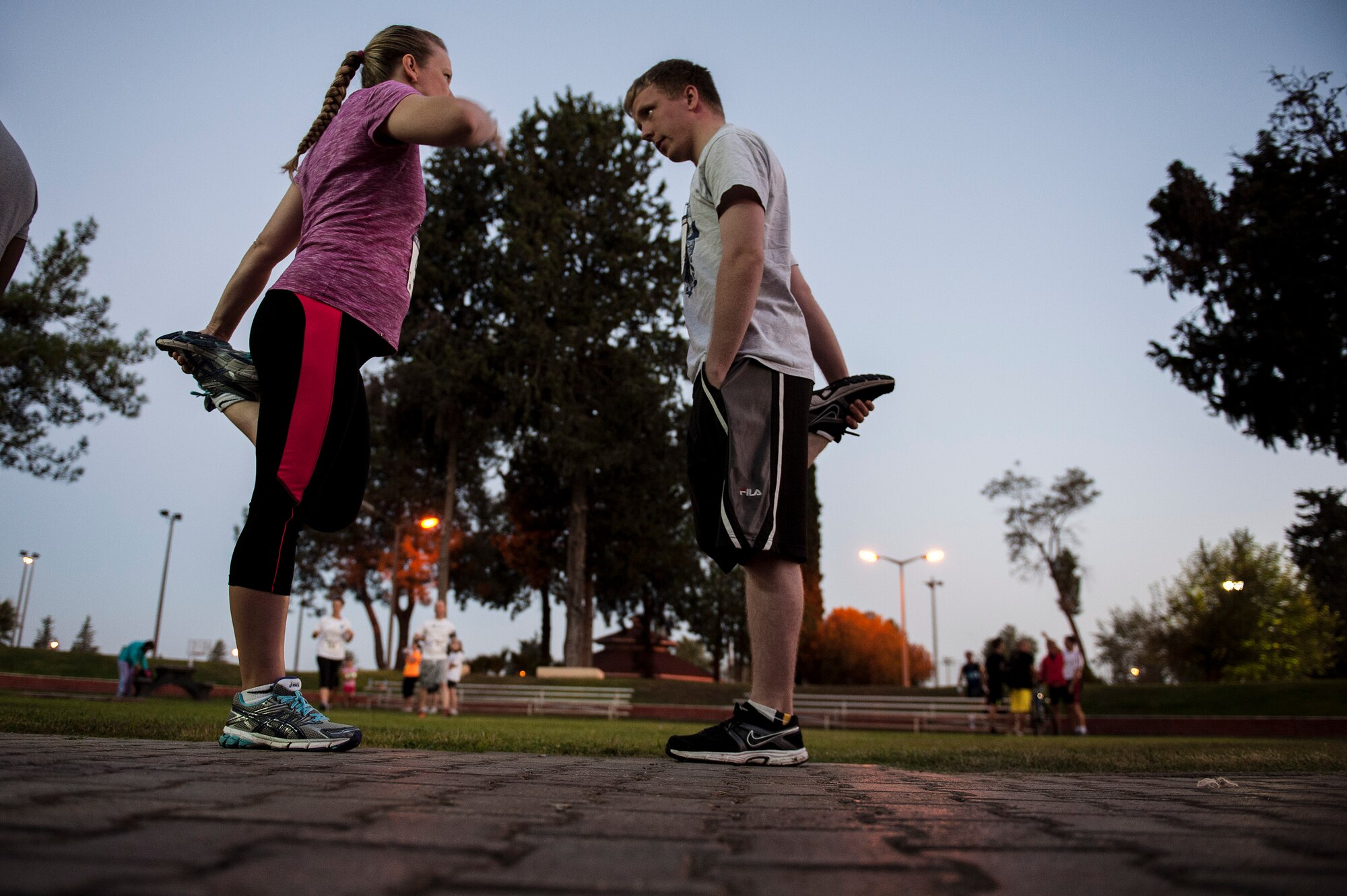 Lisa Howard, Central Texas College field representative, and her son Orion Howard, 39th Force Support Squadron bowling center cashier, stretch before the annual Air Force half-marathon Sept. 14, 2013, at Incirlik Air Base, Turkey.  The 13.1 mile run was their first half-marathon together.  (U.S. Air Force photo by Airman 1st Class Nicole Sikorski/Released)