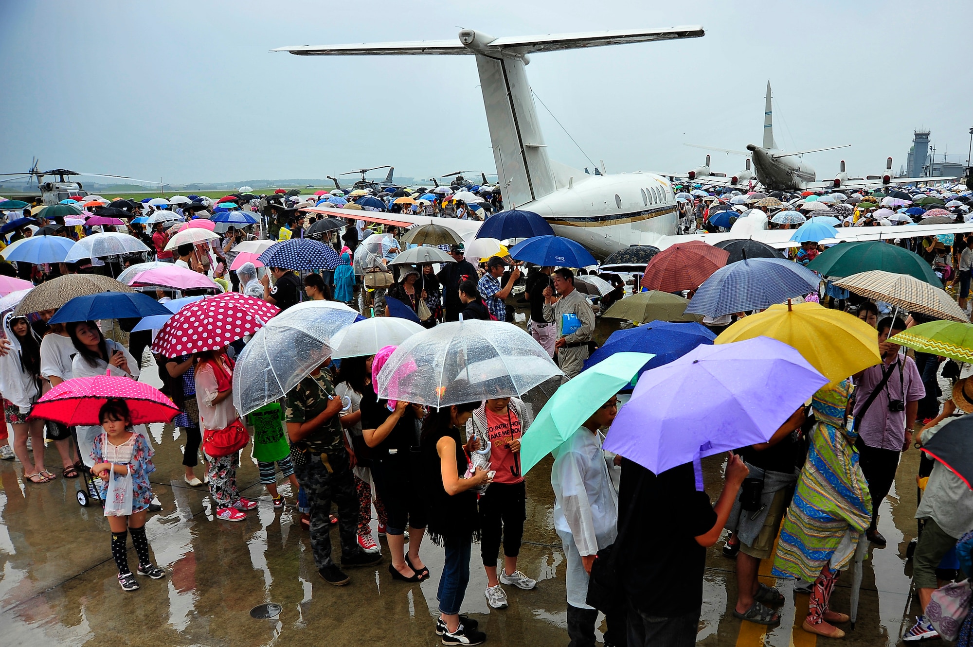 Thousands of visitors walk the flightline during the 2013 Misawa Air Festival at Misawa Air Base, Japan, Sept. 15, 2013. Attendees toured and photographed aircraft from the U.S. Air Force, U.S. Navy and Japan Air Self-Defense Force, and were treated to live music and concessions throughout the day. (U.S. Air Force photo by Staff Sgt. Nathan Lipscomb)