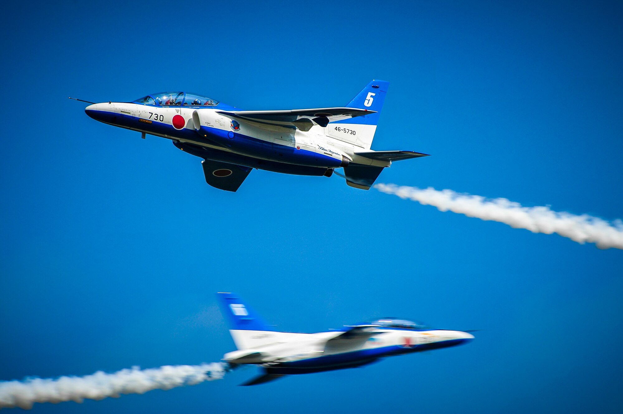 Two planes with the Japan Air Self-Defense Force's demonstration team, Blue Impulse, perform aerial maneuvers during a practice over Misawa Air Base, Japan, Sept. 14, 2013. The team visited Misawa in conjunction with the 2013 air festival where they were highlighted as the headline aerial performers of the weekend. (U.S. Air Force photo by Staff Sgt. Nathan Lipscomb)