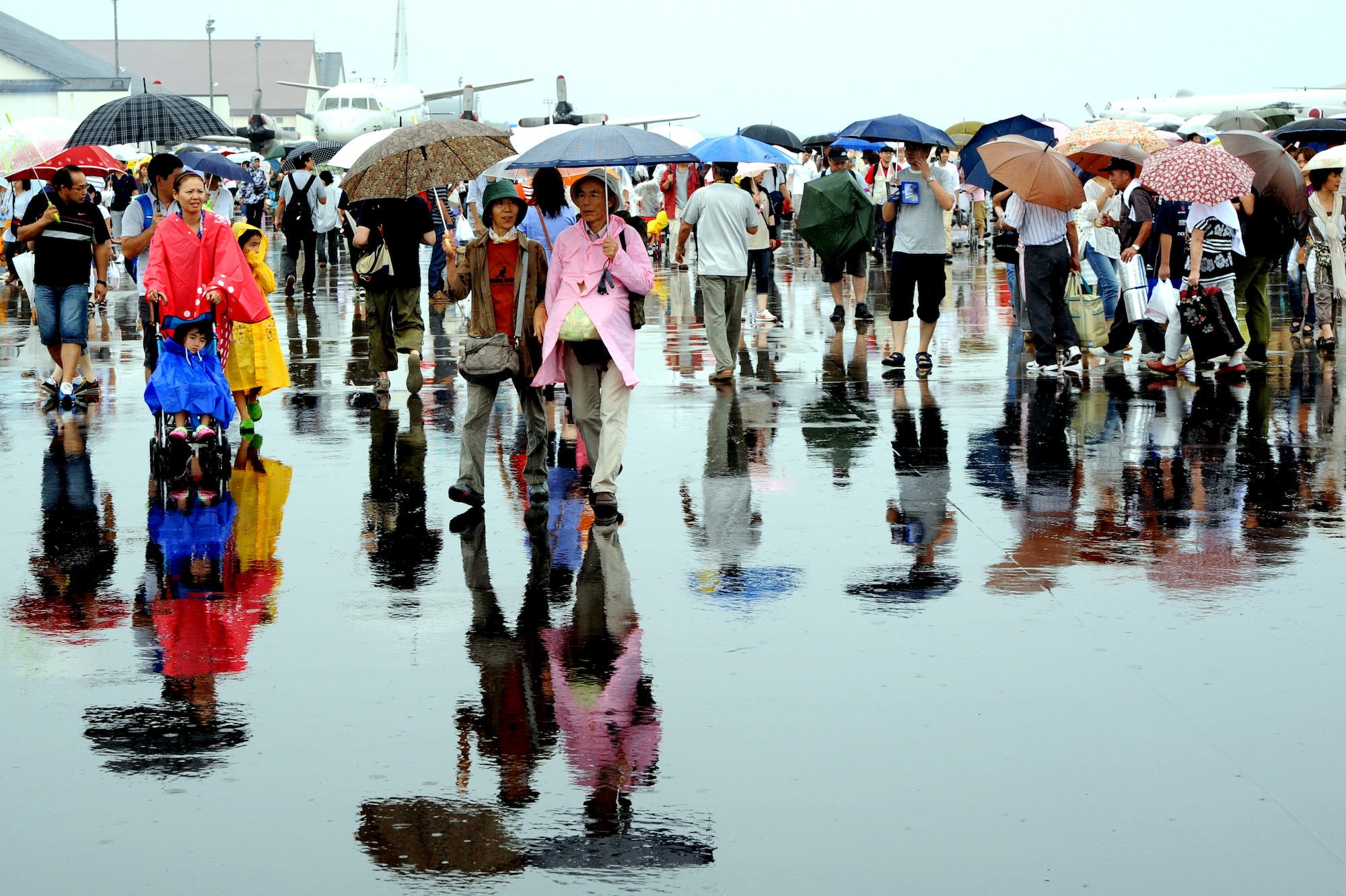 Visitors walk the flight line during the air festival at Misawa Air Base, Japan, Sept. 15, 2013. Aircraft from both the U.S. Air Force and Japan Air Self-Defense force were on display for attendees to tour and photograph. (U.S. Air Force photo by Senior Airman Derek VanHorn)