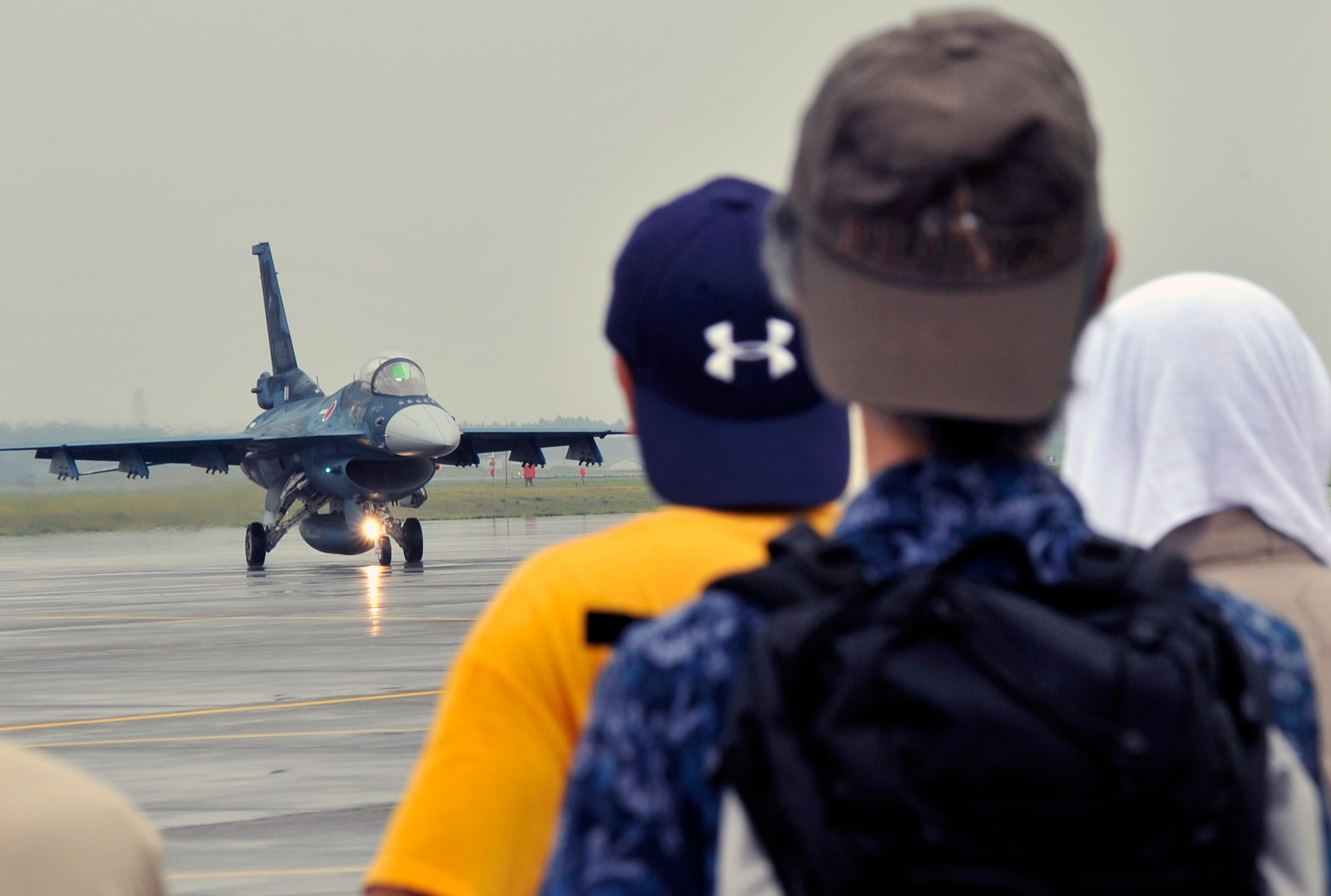 A Japan Air Self-Defense Force F-2 taxies the runway as spectators look on during the 2013 Air Festival at Misawa Air Base, Japan, Sept. 15, 2013. More than 80,000 people attended the event that featured the JASDF’s premier aerial demonstration team, Blue Impulse. However, due to weather, the Blue Impulse could not perform any aerial demonstrations. (U.S. Air Force photo by Airman 1st Class Zachary Kee)