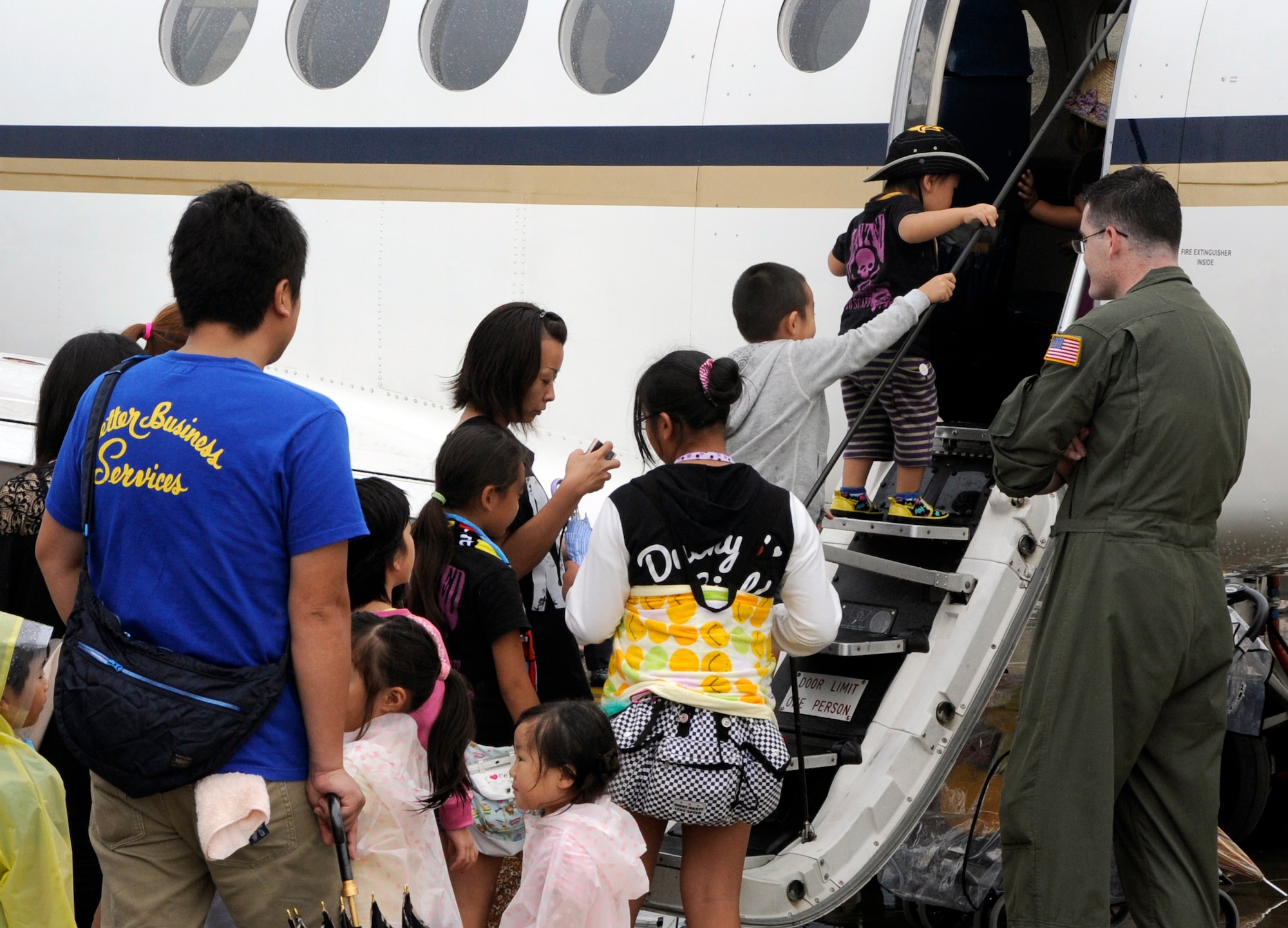 Attendees of the 2013 Misawa Air Festival tour a C-12 aircraft at Misawa Air Base, Japan, Sept. 15, 2013. Visitors were able to view more than 25 different aircraft static displays including the Blue Impulse demonstration team. (U.S. Air Force photo by Airman 1st Class Kaleb Snay)