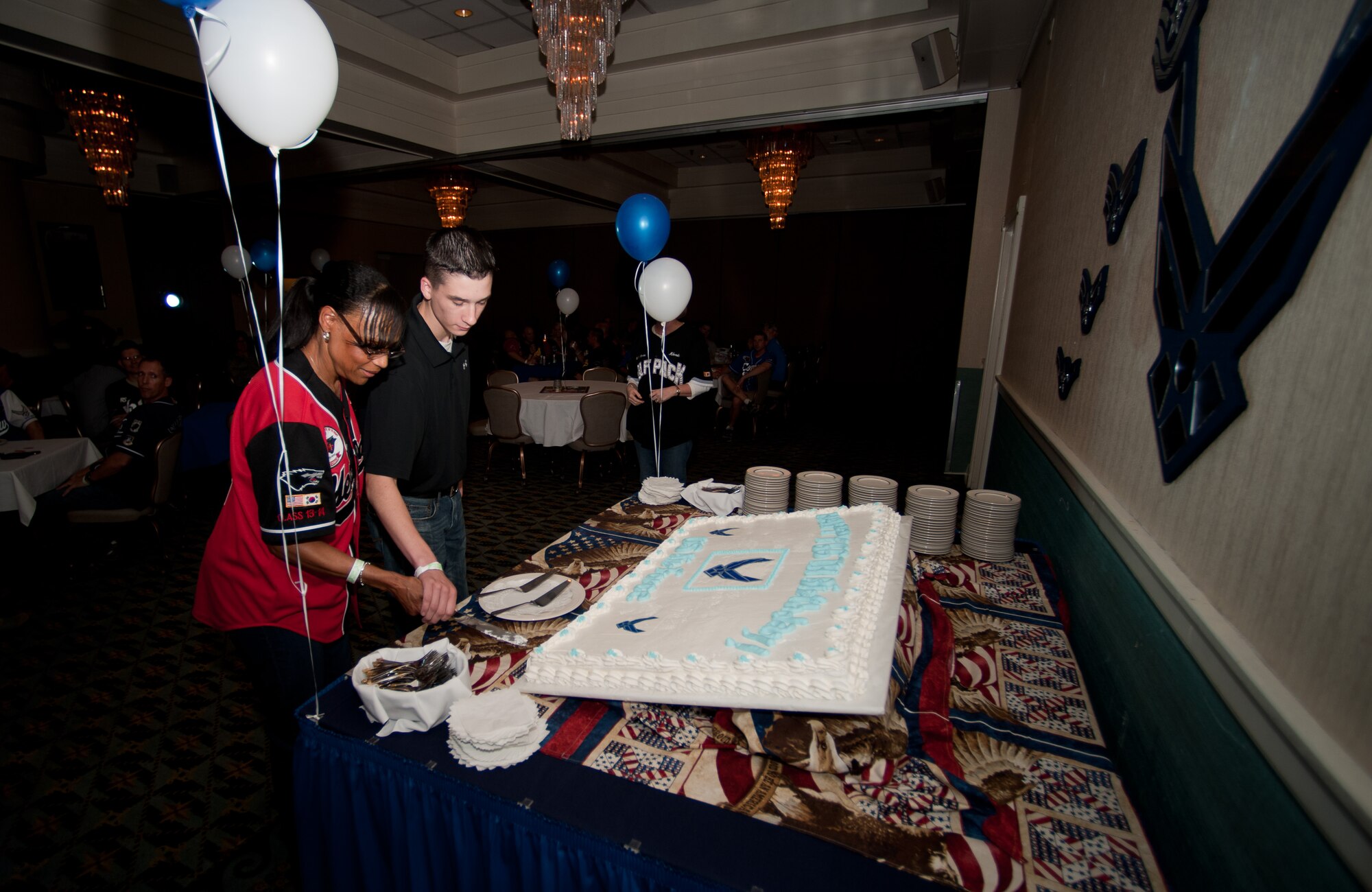 Lt. Col. Mimi Cannonier, 8th Medical Group deputy commander and Airman Joseph Parsons, 8th Logistic Readiness Squadron vehicle operator, cut the Air Force birthday cake at Kunsan Air Base, Republic of Korea, Sept. 13, 2013. The Airmen took part in the tradition of the oldest and youngest Airmen cutting the first piece. (U.S. Air Force photo by Senior Airman Armando A. Schwier-Morales) 