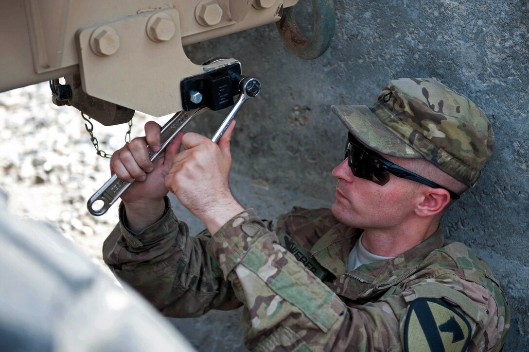 U.S. Army Pfc. Nathan Weber tightens a bolt on a truck on Forward Operating Base Fenty in Nangarhar province, Afghanistan, Sept. 11, 2013. Weber, a wheeled vehicle mechanic, is assigned to the 1st Cavalry Division's 4th Squadron, 9th Cavalry Regiment, 2nd Armored Brigade Combat Team.