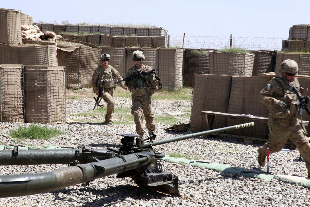 U.S. soldiers rush from a bunker during a react to contact drill for the Guns of Glory top gun competition on Combat Outpost Clark in Khost province, Afghanistan, Sept. 4, 2013.