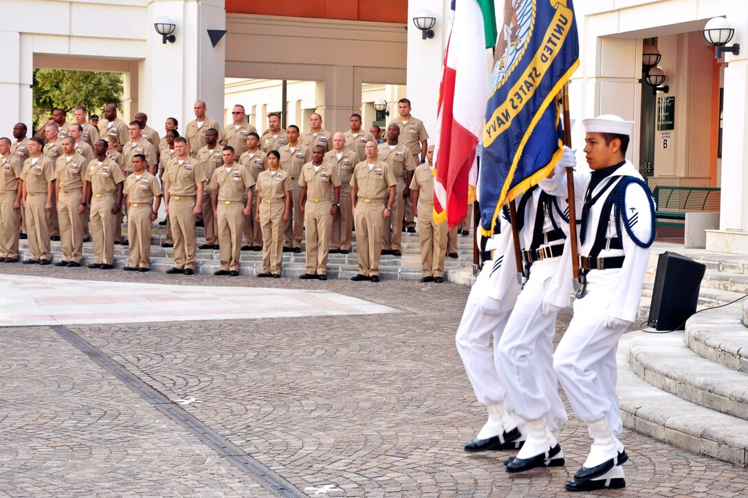 A Navy color guard parades the colors in front of U.S. Navy chief petty officer selects assigned to Commander Naval Forces Europe, Commander Naval Forces Africa and Commander U.S. 6th Fleet during a pinning ceremony at Naval Support Activity Naples, Italy, Sept. 13, 2013.
