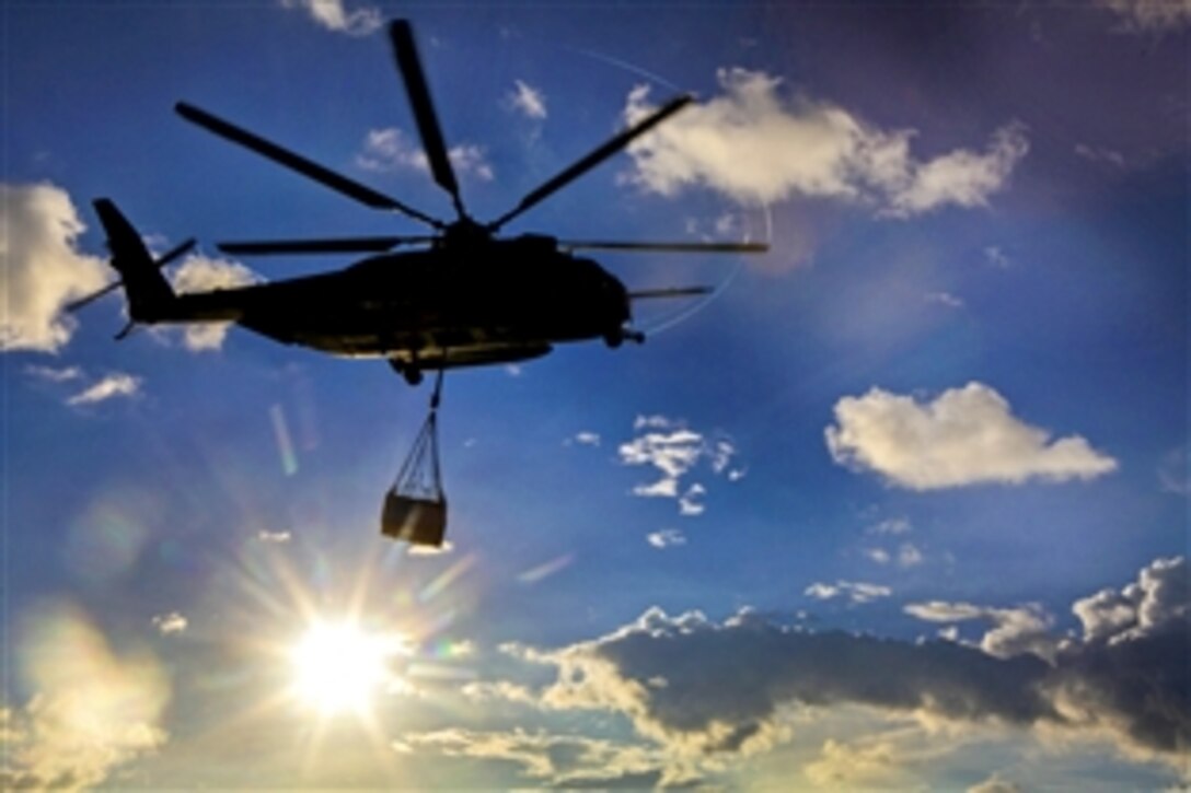 A CH-53E Super Stallion helicopter carries a load of cargo following an external lift from the flight deck on the USS Bonhomme Richard at sea, Sept. 13, 2013. The helicopter's support team and crews play important roles in the unit's capability to execute external lifts. This lift capability can be used to overcome difficult terrain and land-based obstacles.