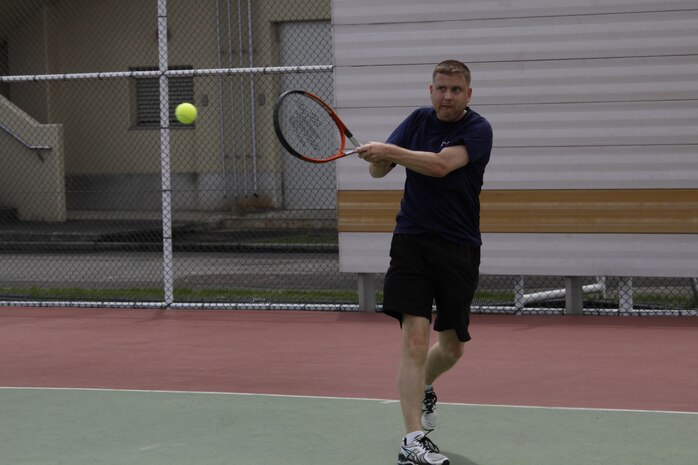 Maj. Jonathan Kehr, Marine Aircraft Group 12 logistics officer, hits a tennis ball during the Commander’s Cup Tennis Tournament held near the Robert M. Casey Medical and Dental Clinic aboard Marine Corps Air Station Iwakuni, Japan, Sept. 6, 2013. Kehr played against Sgt. Michael Ledyard, Marine Wing Support Squadron 171 career planner, during the championship game. Both participants earned points toward their unit's overall Commander's Cup score. The tennis tourney is the second-to-last Commander's Cup event scheduled this year. The final Commander's Cup event is the Gladiators Challenge, which is scheduled to take place Oct. 12 at Penny Lake fields.