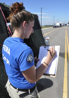 Denise Corrieri, Federal Emergency Management Agency Corps logistics specialist team member, checks a staging list Sept. 16, 2013, at Buckley Air Force Base, Colo. FEMA Corps lent a hand by checking logistics and inventorying trucks in support of flood relief in Colorado. 