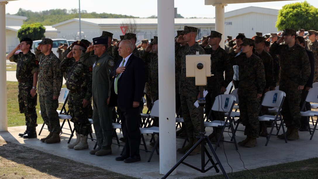 Romanian Col. Loan-Doru Apafaian, executive director of Black Sea Rotational Force Romanian forces, Maj. Jacob Robinson, officer-in-charge of BSRF-14, and other distinguished guests, salute the American and Romanian flag for their respective anthems during the opening ceremony for BSRF-14 at Mihail Kogalniceanu, Romania, Sept. 13th. The opening ceremony marks the beginning of BSRF-14, the first winter rotation of forces in Romania.  BSRF is an annual rotation to promote regional stability and security, increase military capacity and interoperability, as well as bolster and maintain partnerships with their counterparts in Eastern Europe.