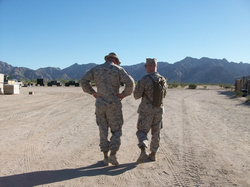 Chaplain Christopher Earley, right, counsels a Marine during a Weapons and Tactics Instructor course at Marine Corps Air Station Yuma, Az., in July of 2010. After 16 years in the Corps, Earley is no stranger to Marine Corps fatigues. 