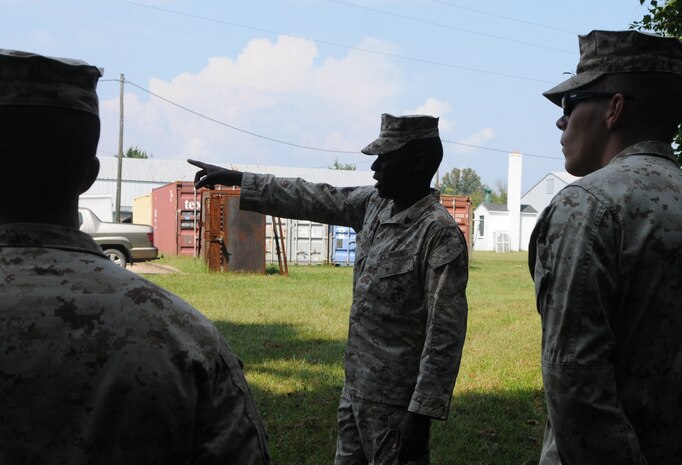During a training session on patrolling, Sgt. Terrance Bowens tells patrolmen Cpl. Brian Lasecki and Lance Cpl. Grant Patterson the course they’ll take across the lawn of Range Management Branch’s backyard. Bowens finished at the top of his Advanced Infantry Course in August and has used what he learned to institute a noncommissioned officer leadership development program at RMB. 