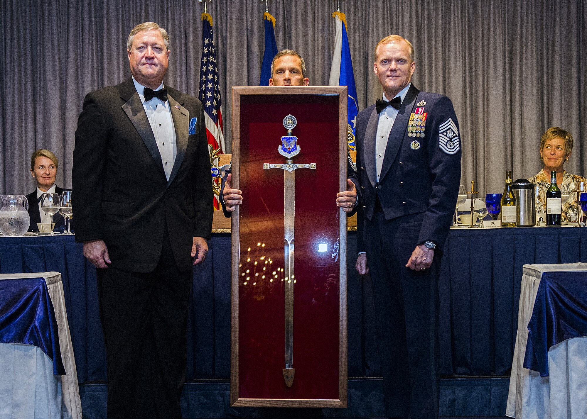 Chief Master Sgt.of the Air Force James Cody inducts the former Secretary of the Air Force Michael Donley into the Order of the Sword during a ceremony on Joint Base Anacostia Bolling, Washington, D.C. on Sept. 13, 2013.