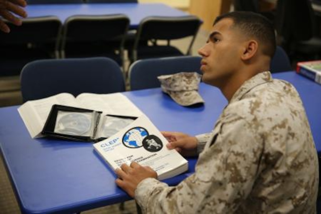Lance Corporal Samuel Ribeiro, an adjutant clerk on Marine Corps Logistics Base Barstow, Calif., receives information from Francis Villeme about the College Level Examination Program, Sept. 9, at the base library. The CLEP, offered to service members free of charge, allows students to test out of a class for college credit without actually going to class.




