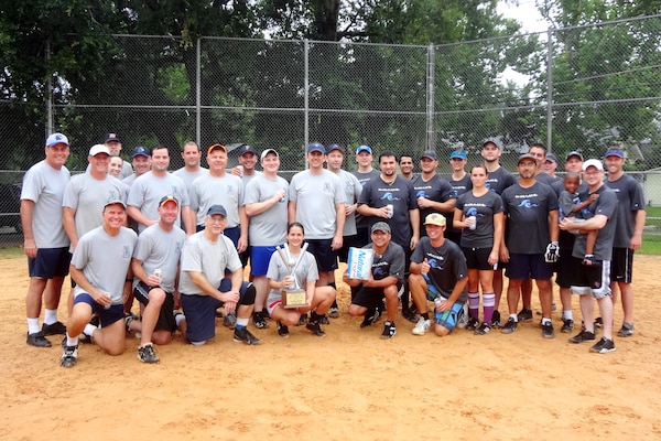 PowerCorps, led by coach Mike Ornella, Sr. (far left) defeated Going Coastal, led by coach Marty Durkin (fourth from right, kneeling) in an all-Corps championship tournament of the Federal Fun League. PowerCorps had a perfect season, capped by their eighth championship in 10 years. 