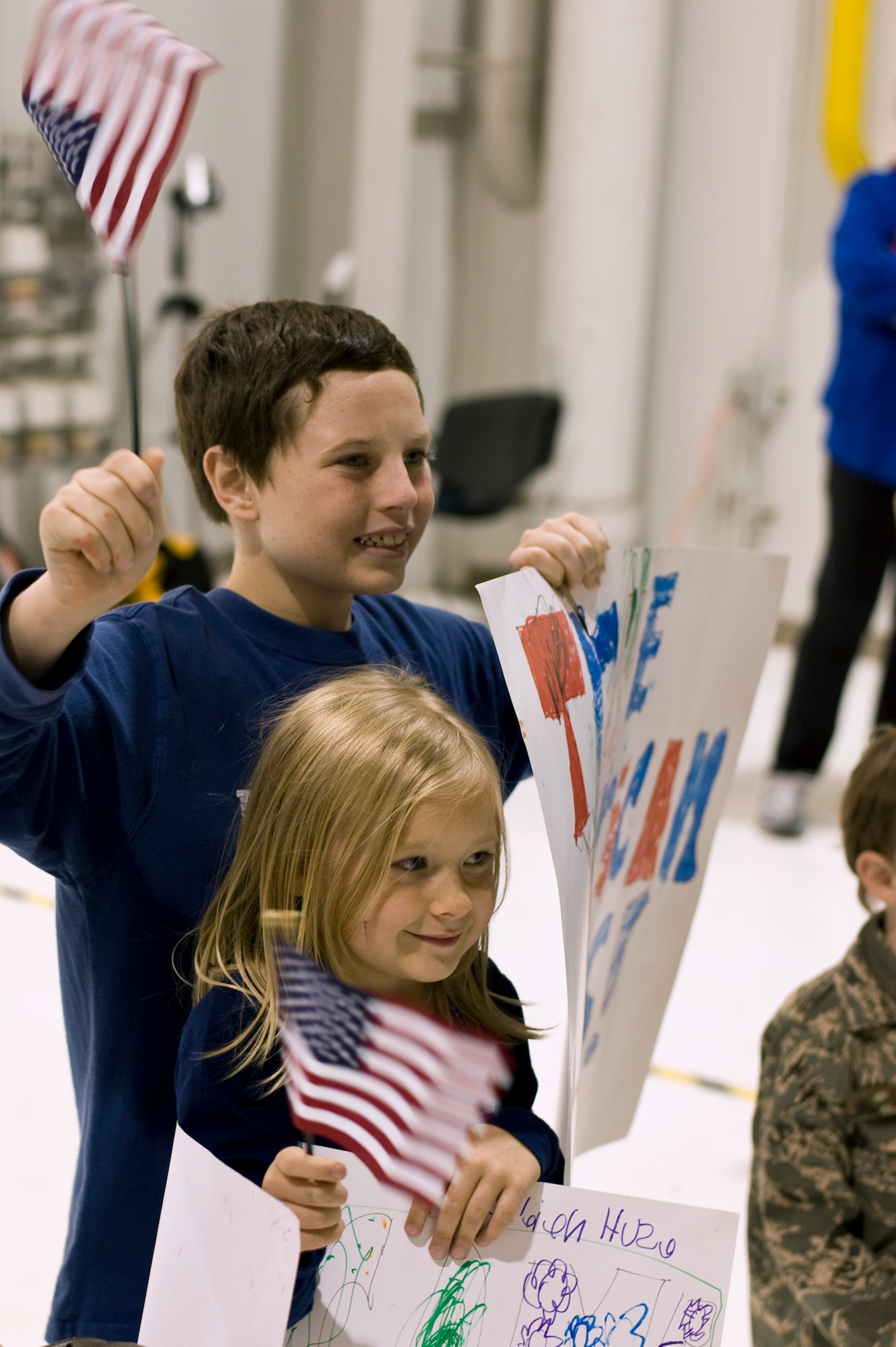 Children welcome veterans returning home Sept. 16, 2013, at the Denver International Airport. The 124 veterans were returning from a trip to Washington where they saw the monuments constructed in their honor. Honor Flight Northern Colorado offers free trips to the district for World War II and Korean War veterans, as well as Purple Heart recipients from any war. (U.S. Air Force photo by Airman 1st Class Riley Johnson/Released)