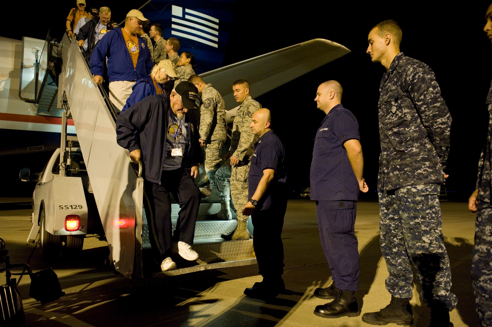 Colorado service members greet veterans as they deplane Sept. 16, 2013, at the Denver International Airport. The 124 veterans were returning from a trip to Washington where they saw the monuments constructed in their honor. Honor Flight Northern Colorado offers free trips to the district for World War II and Korean War veterans, as well as Purple Heart recipients from any war. (U.S. Air Force photo by Airman 1st Class Riley Johnson/Released)