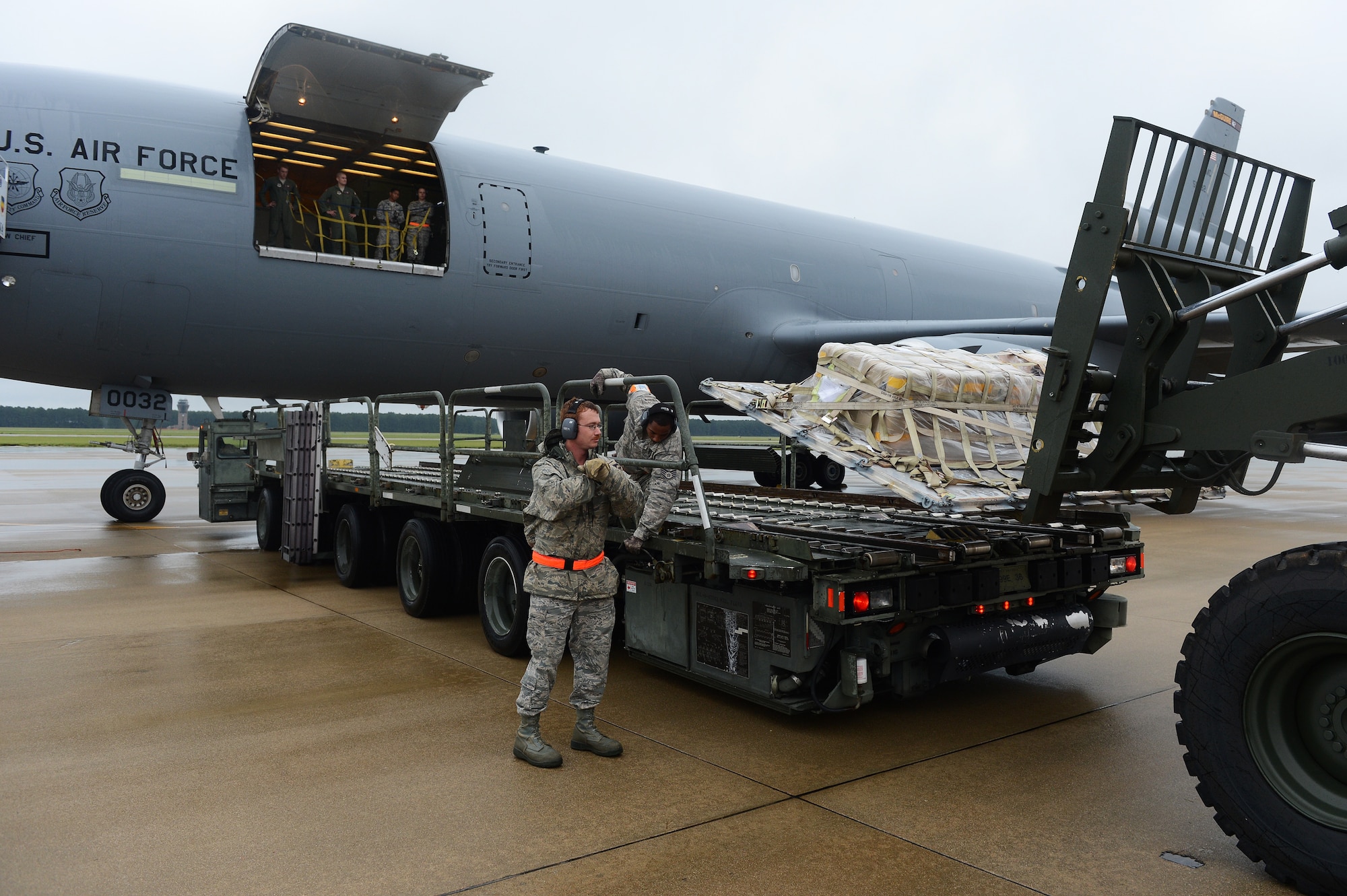 Airmen unload cargo from a KC-10 Extender on the flight line at Shaw Air Force Base, S.C., Aug. 16, 2013. The 20th Logistics Readiness Squadron has recently implemented a new cargo deployment process that aims to standardize packing requirements and ensure unit accountability with the pallets they submit. The plan is projected to reduce necessary manning by 50 percent, ultimately saving the Air Force money through efficiency. (U.S. Air Force photo by Airman 1st Class Daniel Blackwell/Released)