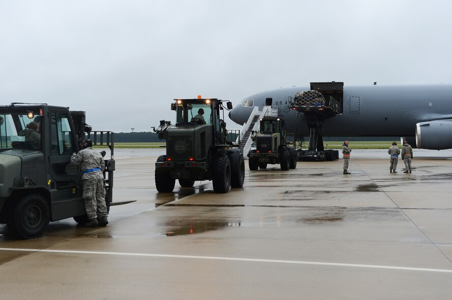 Airmen operating forklifts on the flight line prepare to unload cargo from a KC-10 Extender at Shaw Air Force Base, S.C., Aug. 16, 2013. The 20th Logistics Readiness Squadron has recently implemented a new cargo deployment process that aims to standardize packing requirements and ensure unit accountability with the pallets they submit. The plan is projected to reduce necessary manning by 50 percent, ultimately saving the Air Force money through efficiency. (U.S. Air Force photo by Airman 1st Class Daniel Blackwell/Released)