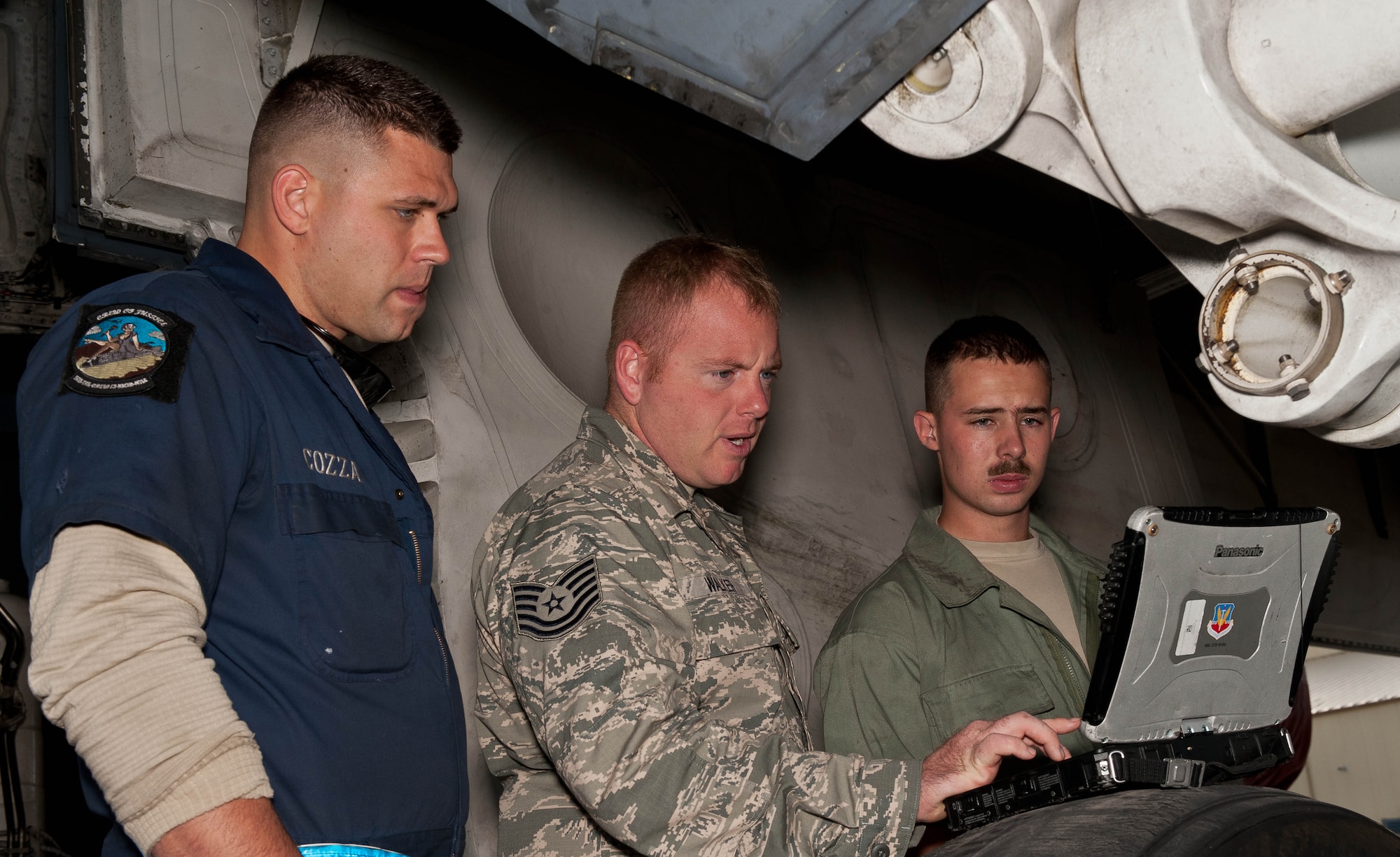 Tech. Sgt. Ryan Walker (middle), Senior Airman Ryan Cozza (left) and Airman 1st Class William Becker, 28th Aircraft Maintenance Squadron B-1 bomber crew chiefs, review a technical order during a pre-flight inspection at Ellsworth Air Force Base, S.D., Sept. 10, 2013. Among their vast responsibilities crew chiefs maintain and repair aircraft parts and perform general mechanical work. (U.S. Air Force photo by Airman 1st Class Zachary Hada/Released)