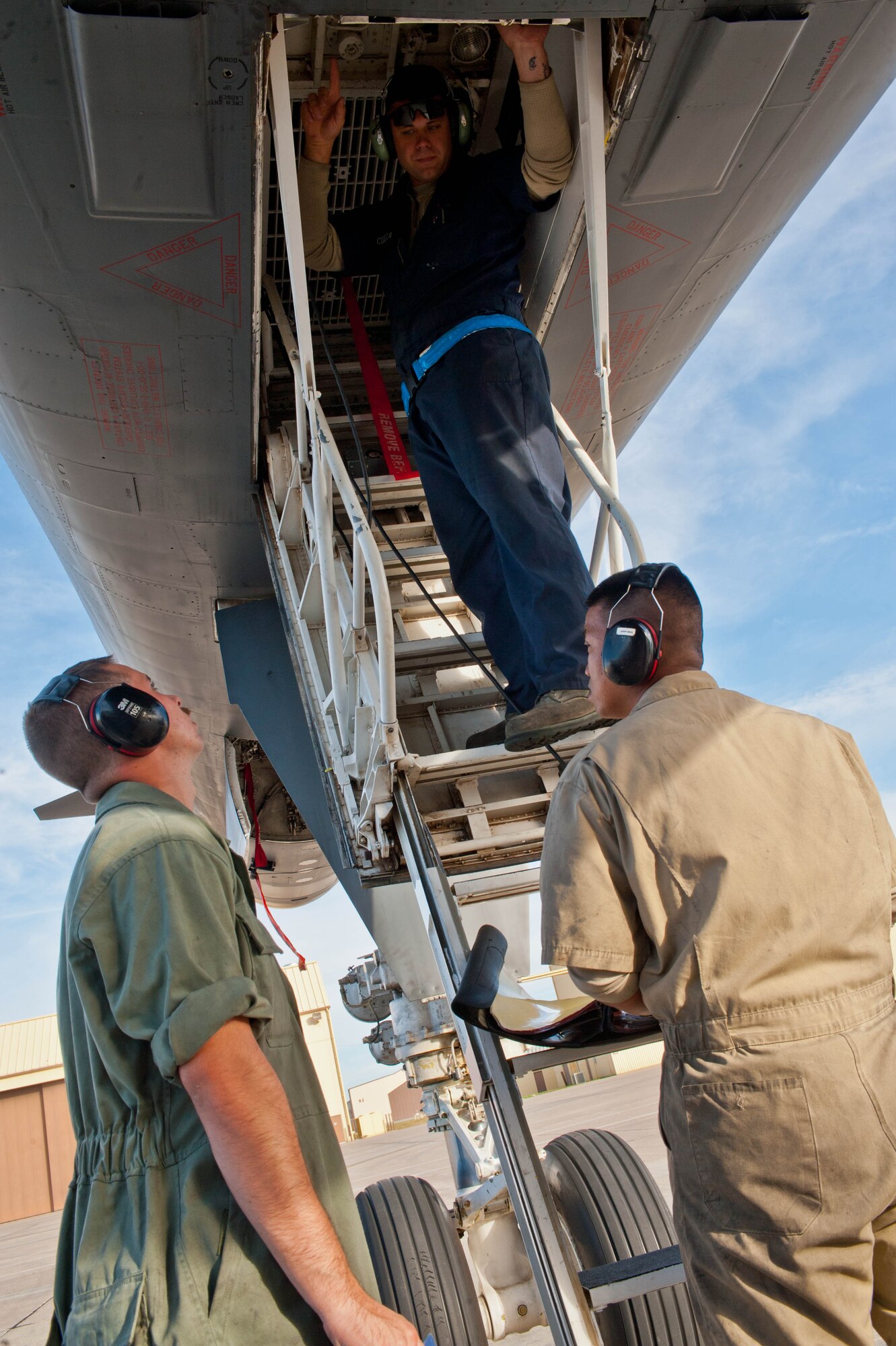 Staff Sgt. Mark Duque (right), Senior Airman Robert Cozza (middle) and Airman 1st Class William Becker, 28th Aircraft Maintenance Squadron B-1 bomber crew chiefs, conduct pre-flight checks on a B-1 at Ellsworth Air Force Base, S.D., Sept. 10, 2013. During pre-flight inspections, crew chiefs examine the exterior and interior of aircraft for any abnormalities. (U.S. Air Force photo by Airman 1st Class Zachary Hada/Released)