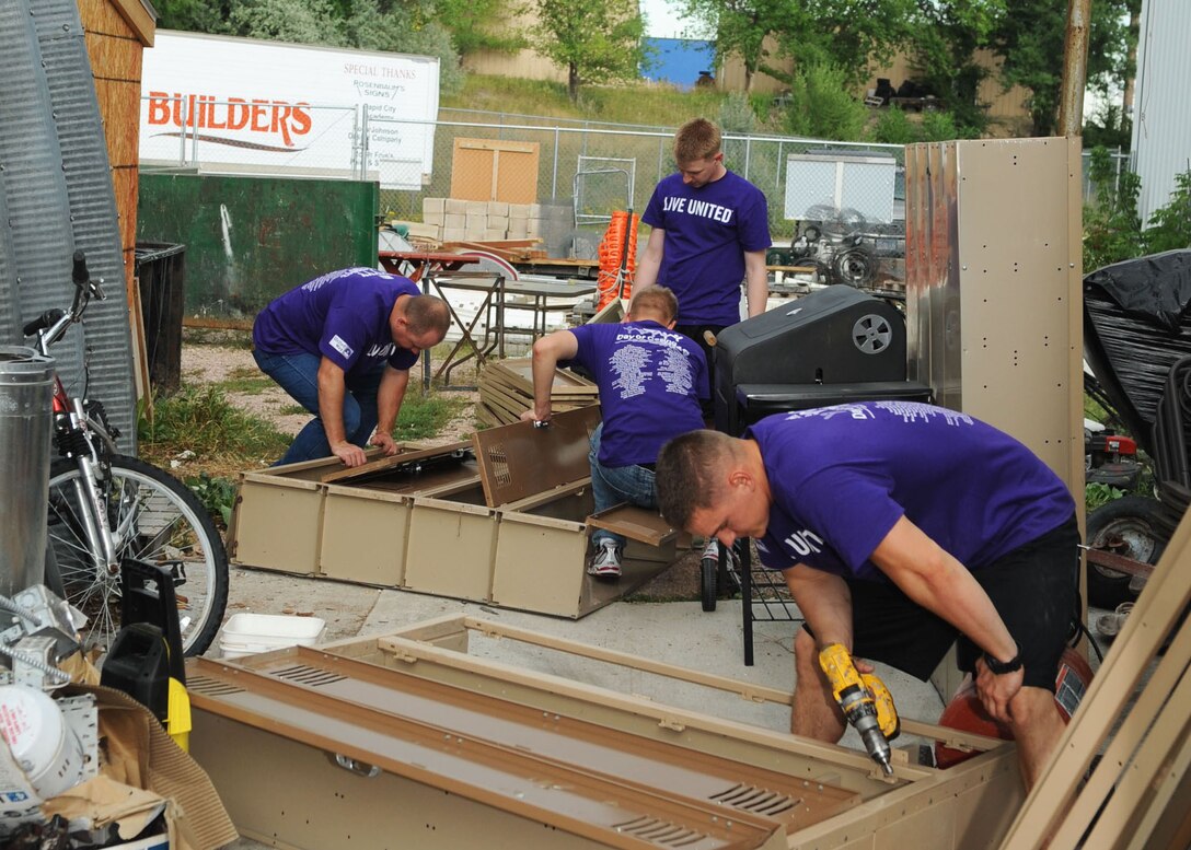 Airmen from the 28th Civil Engineer Squadron team up to complete a volunteer project at the local Habitat for Humanity ReStore building during the United Way of the Black Hills Day of Caring in Rapid City, S.D., Sept. 5, 2013. More than 320 Ellsworth Airmen joined volunteers across the region to complete nearly 100 projects in the Black Hills, strengthening the ties between Ellsworth and its local communities.  (U.S. Air Force photo by Airman 1st Class Rebecca Imwalle/Released)