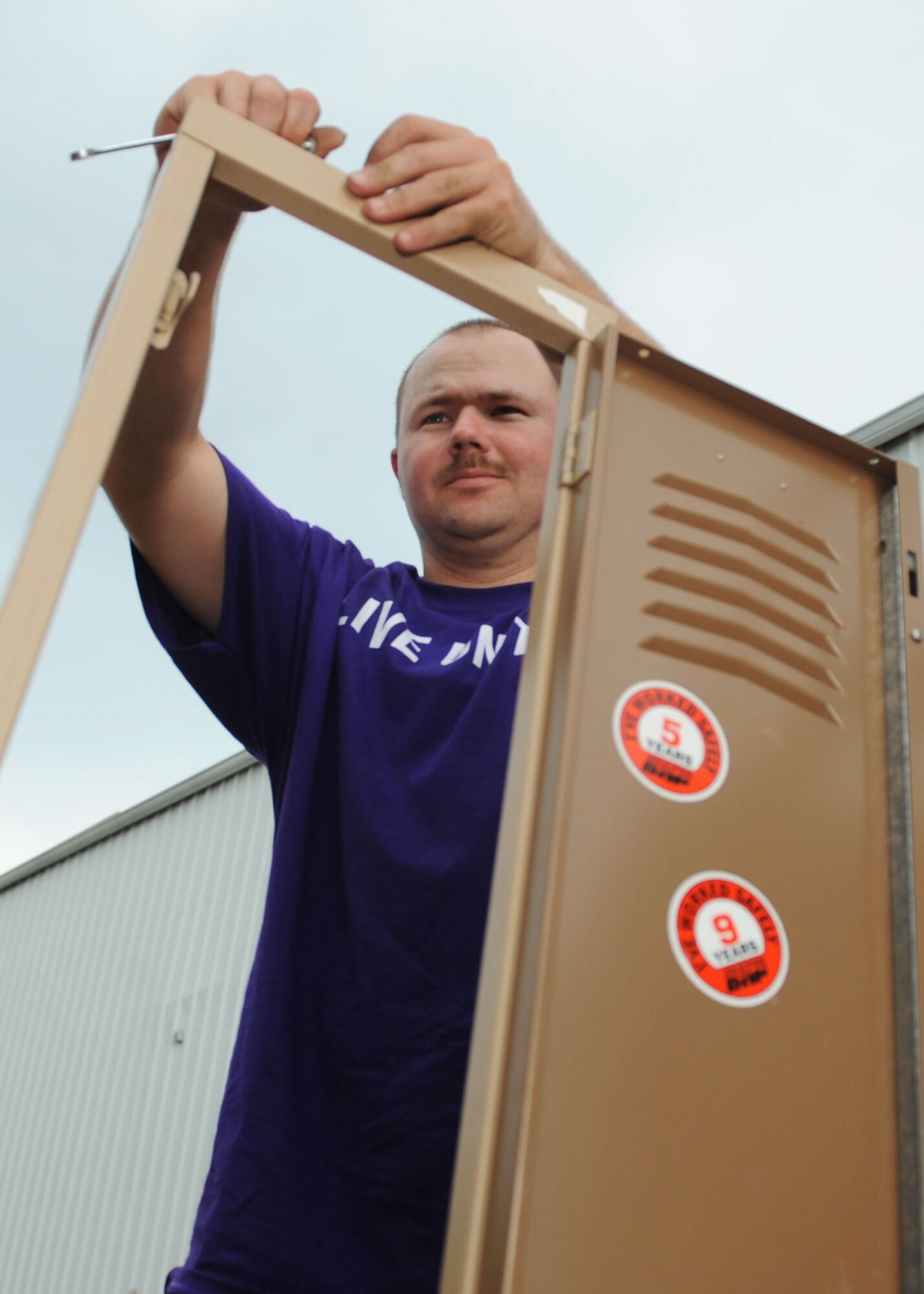 Staff Sgt. Aaron Walker, 28th Civil Engineer Squadron water and fuels systems technician, disassembles lockers at the Black Hills Habitat for Humanity ReStore during the United Way of the Black Hills Day of Caring in Rapid City, S.D., Sept. 5, 2013. Airmen volunteered their time to support more than 60 local organizations including Habitat for Humanity, the Club for Boys, and the Rapid City YMCA. (U.S. Air Force photo by Airman 1st Class Rebecca Imwalle/Released)