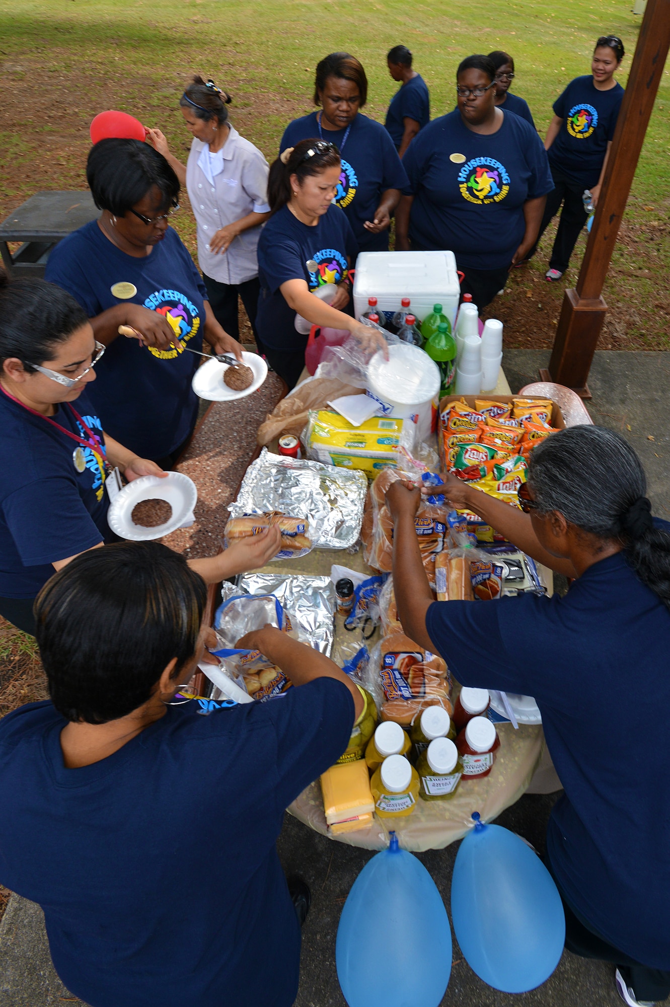 Carolina Pines Inn workers prepare to eat during a luncheon held as part of international housekeeping week, Shaw Air Force Base, S.C., Sept. 13, 2013. International housekeeping week is an Air Force-wide event, held on many bases to show appreciation for the hard work that housekeepers do and give them a chance to relax and have fun. (U.S. Air Force photo by Airman 1st Class Jensen Stidham/Released)