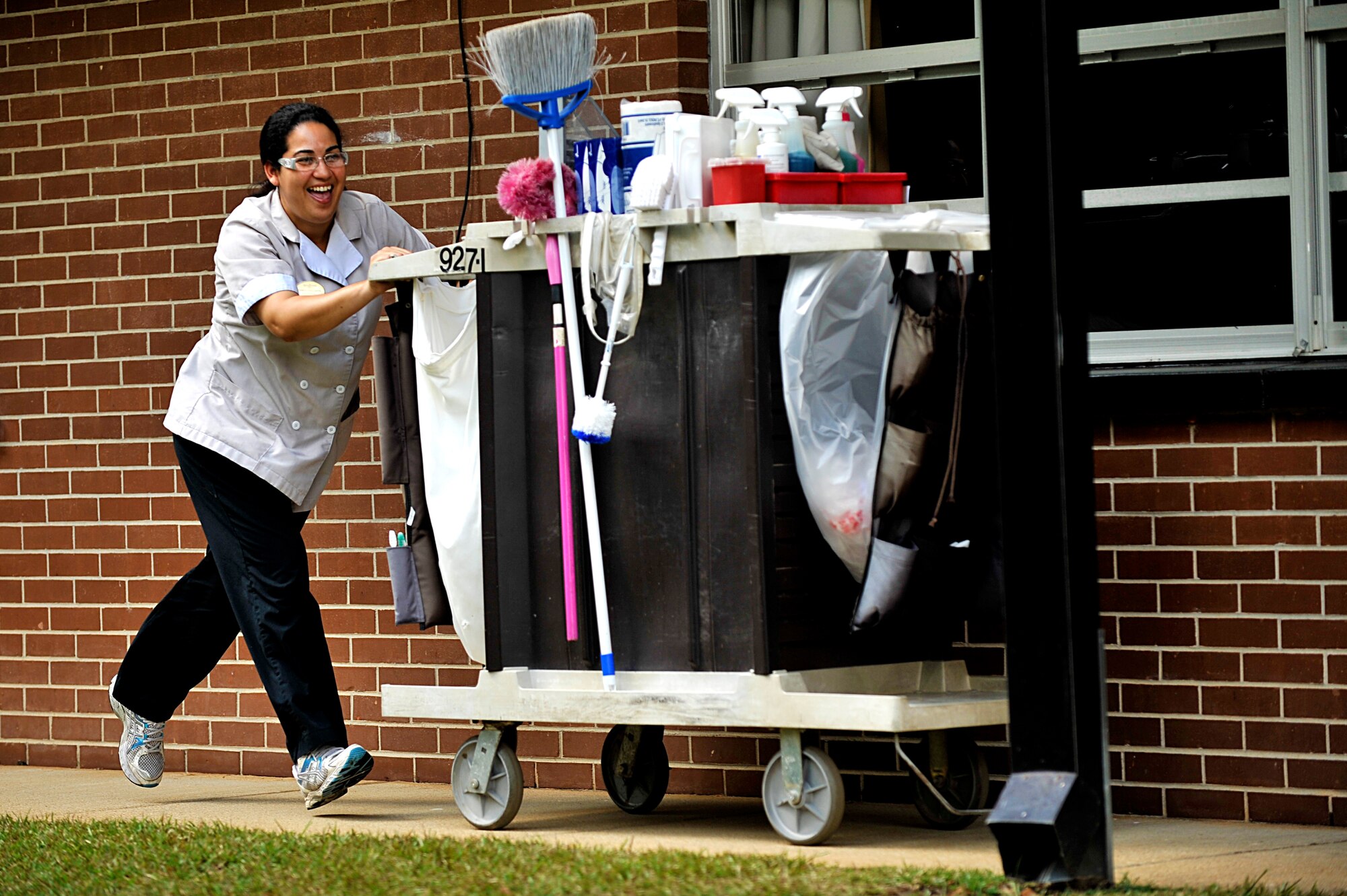 Beatriz Ortizcastillo, Carolina Pines Inn housekeeper, pushes a cart during a race held as part of international housekeeping week, Shaw Air Force Base, S.C., Sept. 13, 2013. International housekeeping week is an Air Force-wide event, held on many bases to show appreciation for the hard work that housekeepers do and give them a chance to relax and have fun. (U.S. Air Force photo by Airman 1st Class Jensen Stidham/Released)