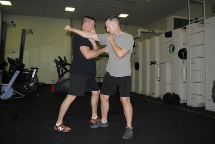 Col. James Gifford, 12th Flying Training Wing vice commander, practices a brush block and punch to floating ribs technique on Lt. Col. Chris McMonnies, 39th Flying Training Squadron instructor pilot.  Gifford is a Hachidan, or eighth degree black belt, in Shinmei Shorin-Ryu Karatejutsu and Shinto Yoshin-Ryu Jujitsu; he has practiced martial arts for more than 30 years.  (U.S. Air Force photo by Bekah Clark)