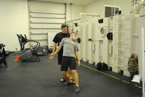 Col. James Gifford, 12th Flying Training Wing vice commander, practices a neck lock and takedown technique on Lt. Col. Chris McMonnies, 39th Flying Training Squadron instructor pilot.  Gifford is a Hachidan, or eighth degree black belt, in Shinmei Shorin-Ryu Karatejutsu and Shinto Yoshin-Ryu Jujitsu; he has practiced martial arts for more than 30 years.  (U.S. Air Force photo by Bekah Clark)