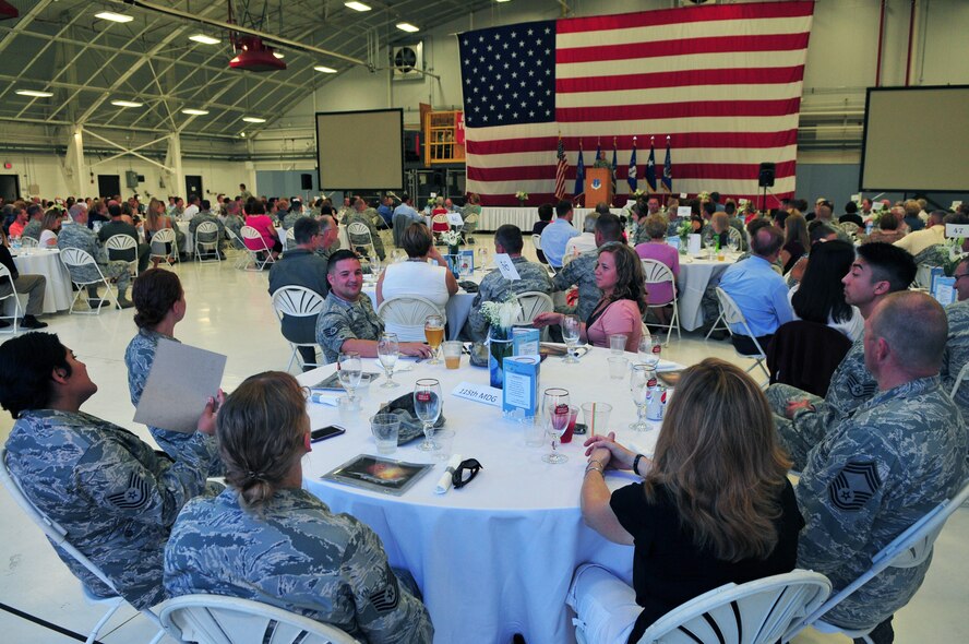 Members of the 115th Fighter Wing and their guests socialize at table as they wait for the presentation of colors during the fighter wing's anniversary celebration at Truax Field, Madison, Wis., Sept. 7. The unit, which was established in September of 1948, celebrated its 65th anniversary over the September unit training assembly. (Air National Guard photo by 1st Lt. Stephen Montgomery) 
