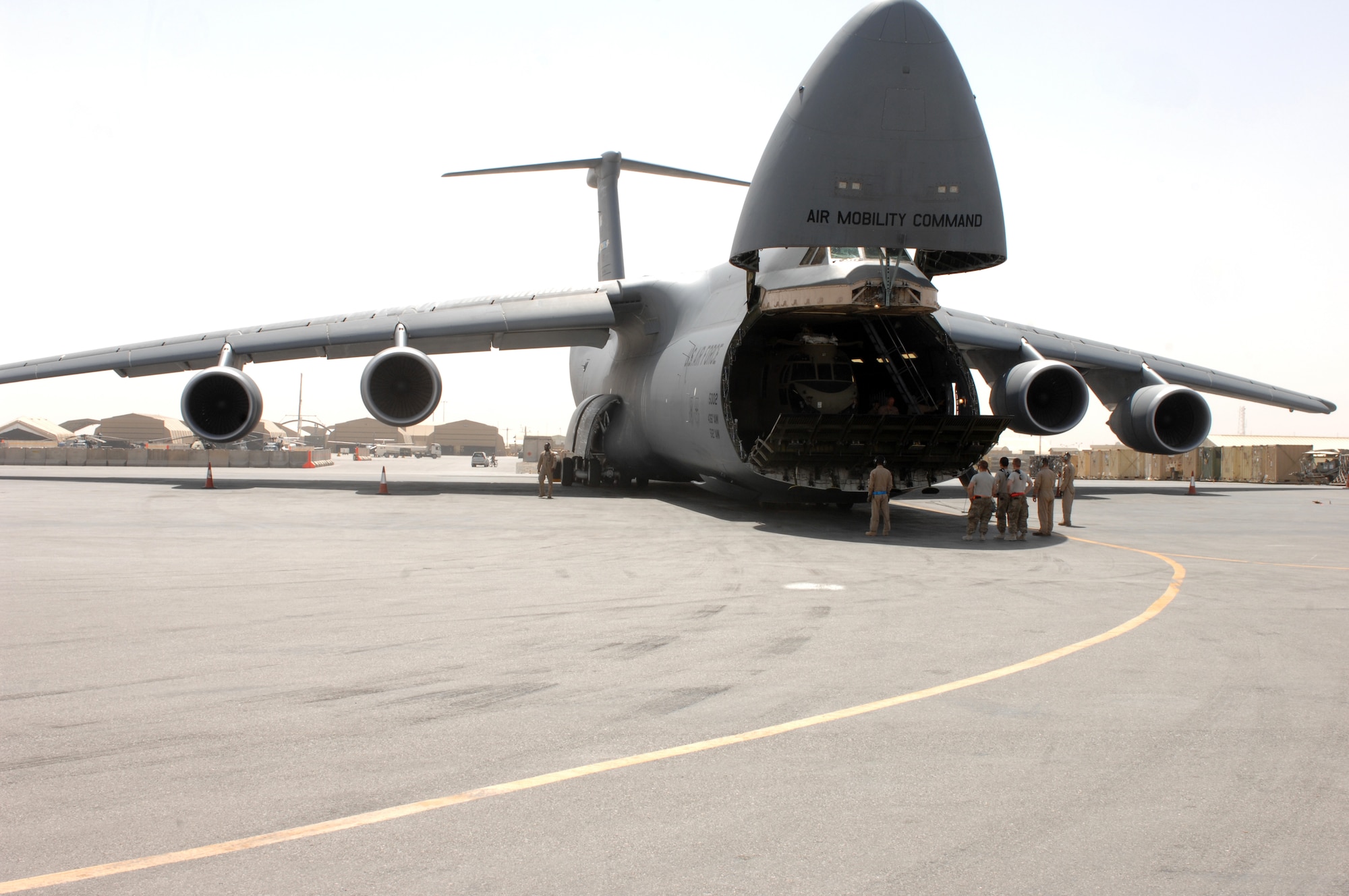 Soldiers from Bravo Company, 651st Aviation Support Battalion, 1st Combat Aviation Brigade, wait to unload two Chinook helicopters from a C-5M Super Galaxy from Dover Air Force Base, Del., at Kandahar Airfield, Afghanistan, Aug. 24, 2013. The 1st CAB will be replacing the 3rd CAB here. (U.S. Air Force photo by Senior Airman Jack Sanders)