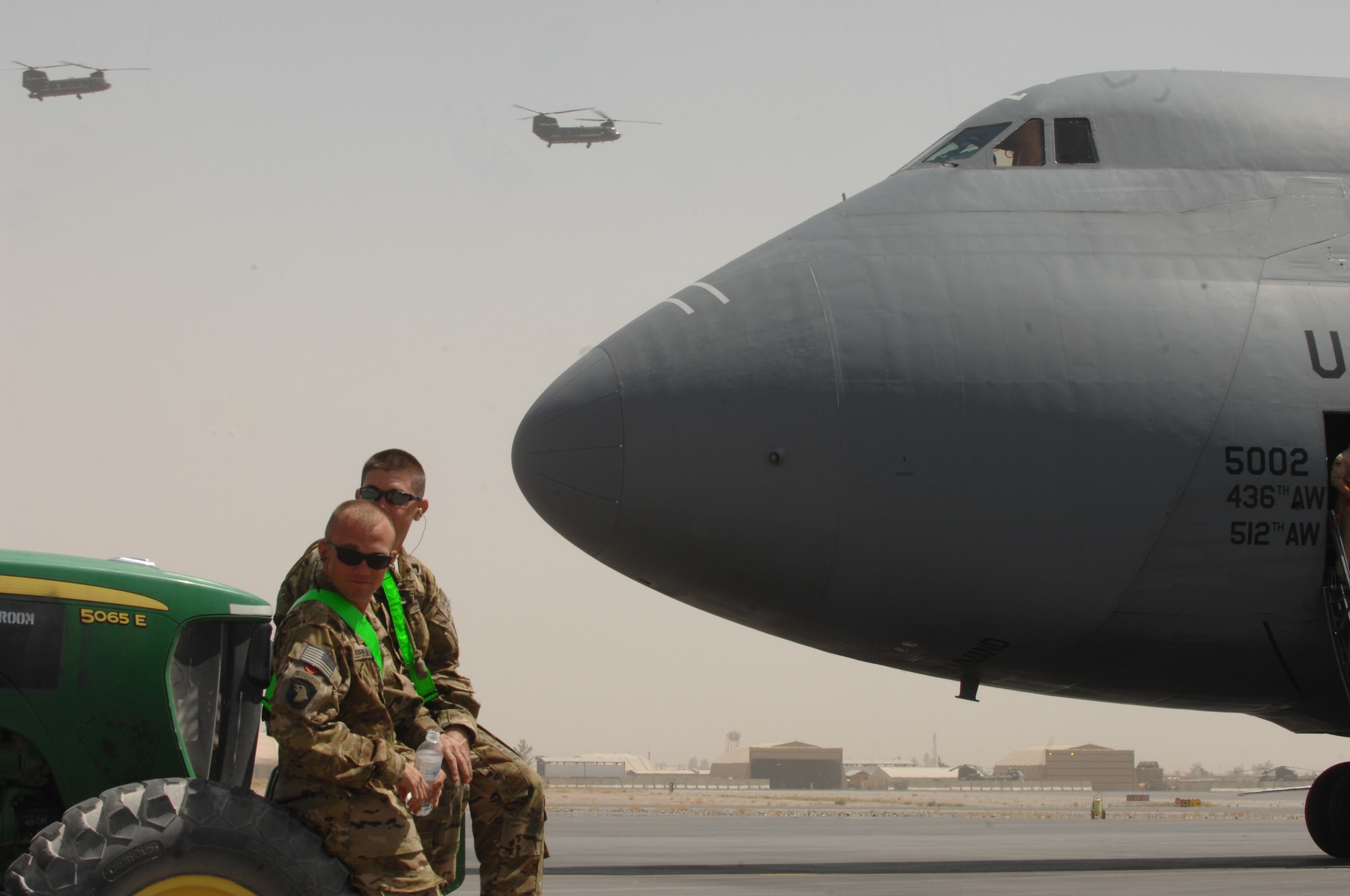Soldiers from Bravo Company, 651st Aviation Support Battalion, 1st Combat Aviation Brigade, wait to unload two Chinook helicopters from a C-5M Super Galaxy from Dover Air Force Base, Del., at Kandahar Airfield, Afghanistan, Aug. 24, 2013. The 1st CAB will be replacing the 3rd CAB here. (U.S. Air Force photo/Senior Airman Jack Sanders)