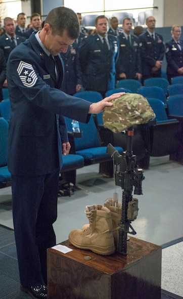 U.S. Air Force Chief Master Sgt. Matthew Wells, 23d Wing command chief, collects his final thoughts at a memorial service for Staff Sgt. Todd Lobraico Jr. at Moody Air Force Base, Ga., Sept. 16, 2013. Lobraico died Sept. 5 from wounds sustained when enemy forces attacked his unit near Bagram Airfield, Afghanistan. (U.S. Air Force photo by Airman 1st Class Ryan Callaghan/Released)