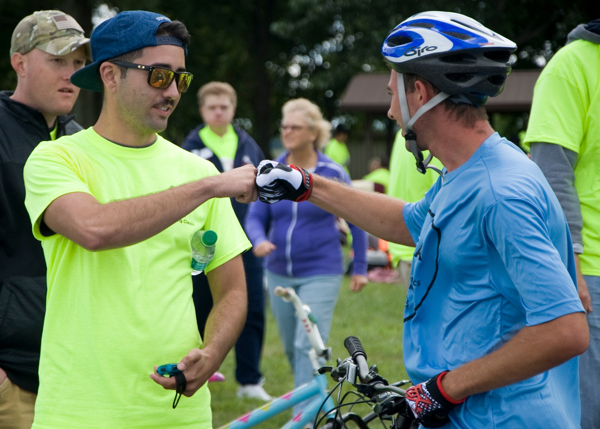 Senior Airman Anthony Calvillo, 436th Aerial Port Squadron cargo processer, fist bumps Matthew Himmelreich, Special Olympian from Pennsylvania, following Himmelreich’s race Sept. 14, 2013, on Dover Air Force Base, Del. Team Dover volunteers kept time and provided words of encouragement to the athletes. (U.S. Air Force photo/Senior Airman Jared Duhon)