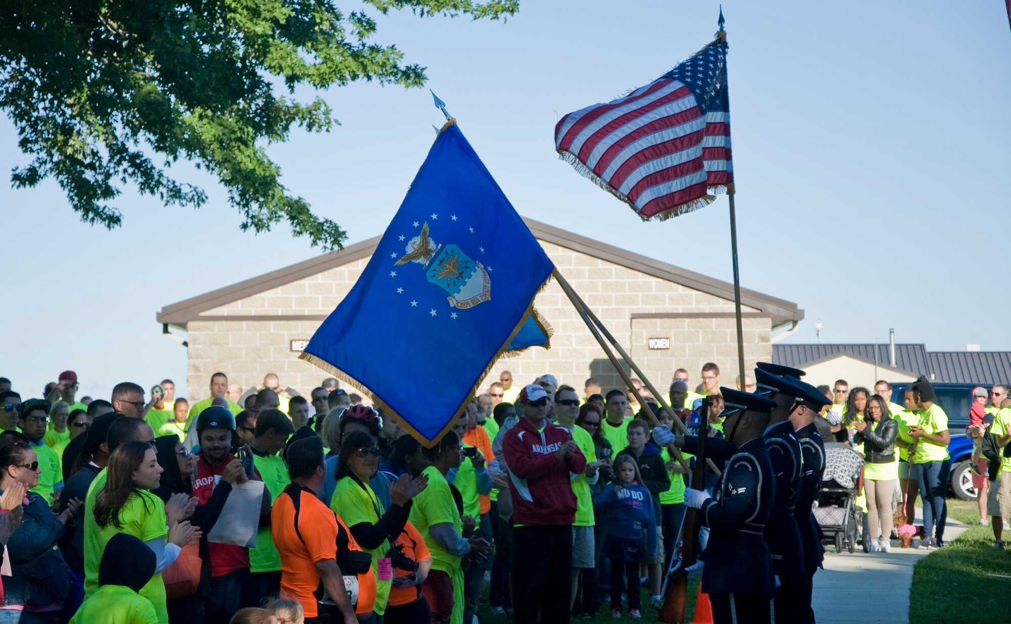The Dover Air Force Base honor guard renders the colors before the opening ceremonies of the Special Olympics of Delaware Cycling Classic Sept. 14, 2013, on Dover AFB, Del. Team Dover provided Special Olympics of Delaware volunteers and a location for the event. (U.S. Air Force photo/Senior Airman Jared Duhon)