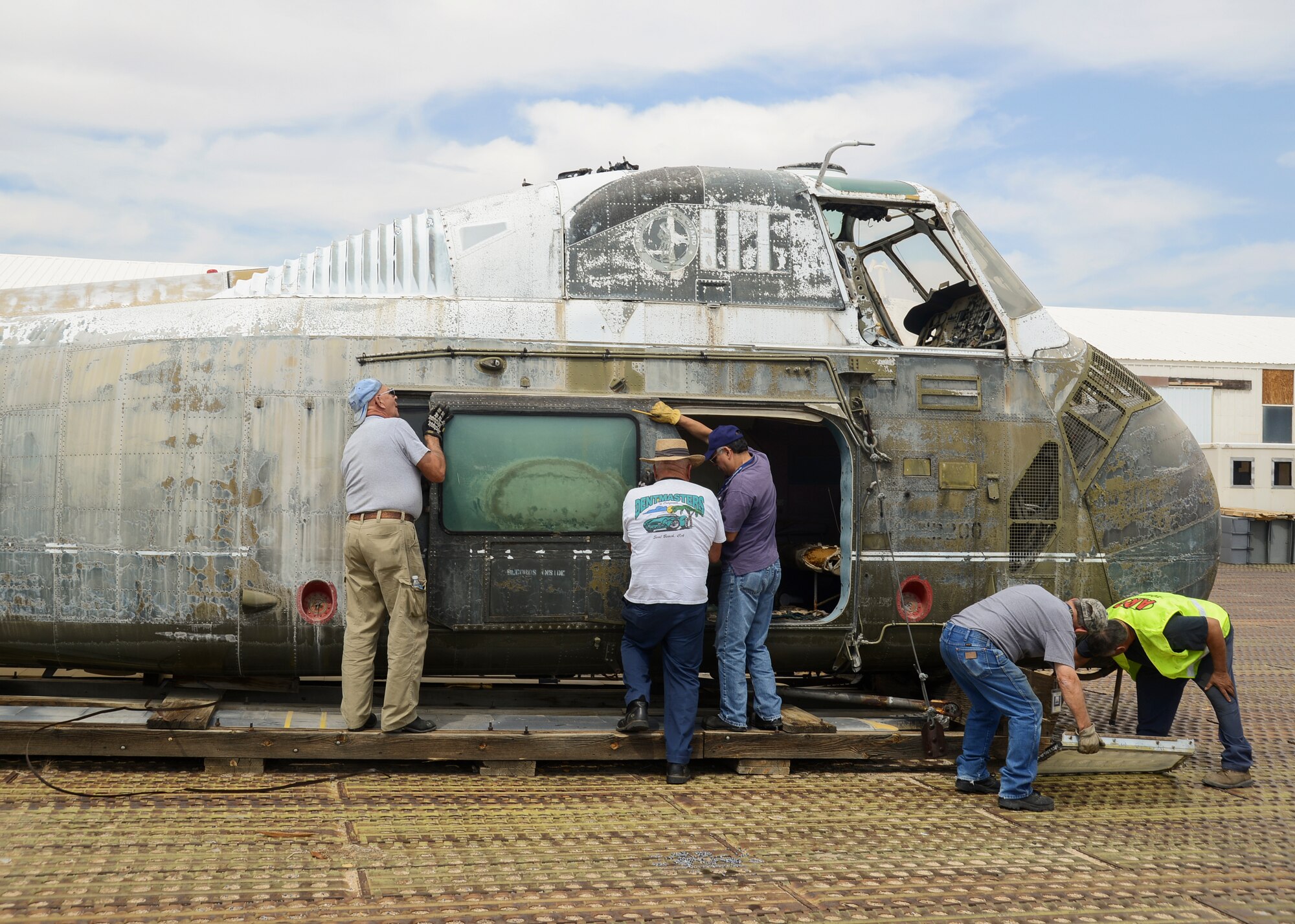 A team of Air Force Flight Test museum volunteers worked to secure the loose fixtures on the helicopter prior to the move. (U.S. Air Force photo by Rebecca Amber) 
