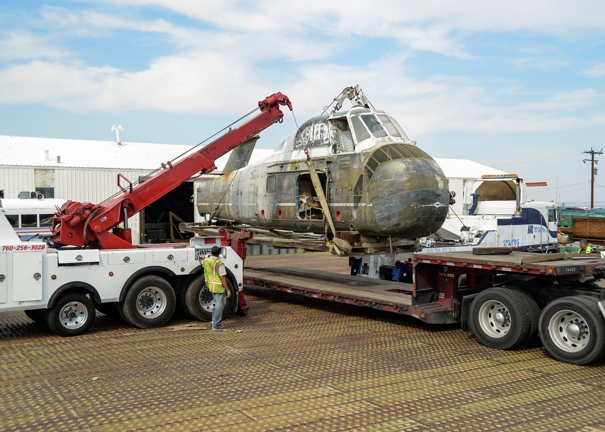 412th Mission Support Group Vehicle Operations personnel carefully lift the Sikorsky VH-34 and wooden pallet onto a lowboy truck, which was then transported to Austin, Texas. The white top helicopter, once used to transport President Lyndon Johnson, will be externally restored at the Texas Military Forces Museum for outdoor display. (U.S. Air Force photo by Rebecca Amber) 
